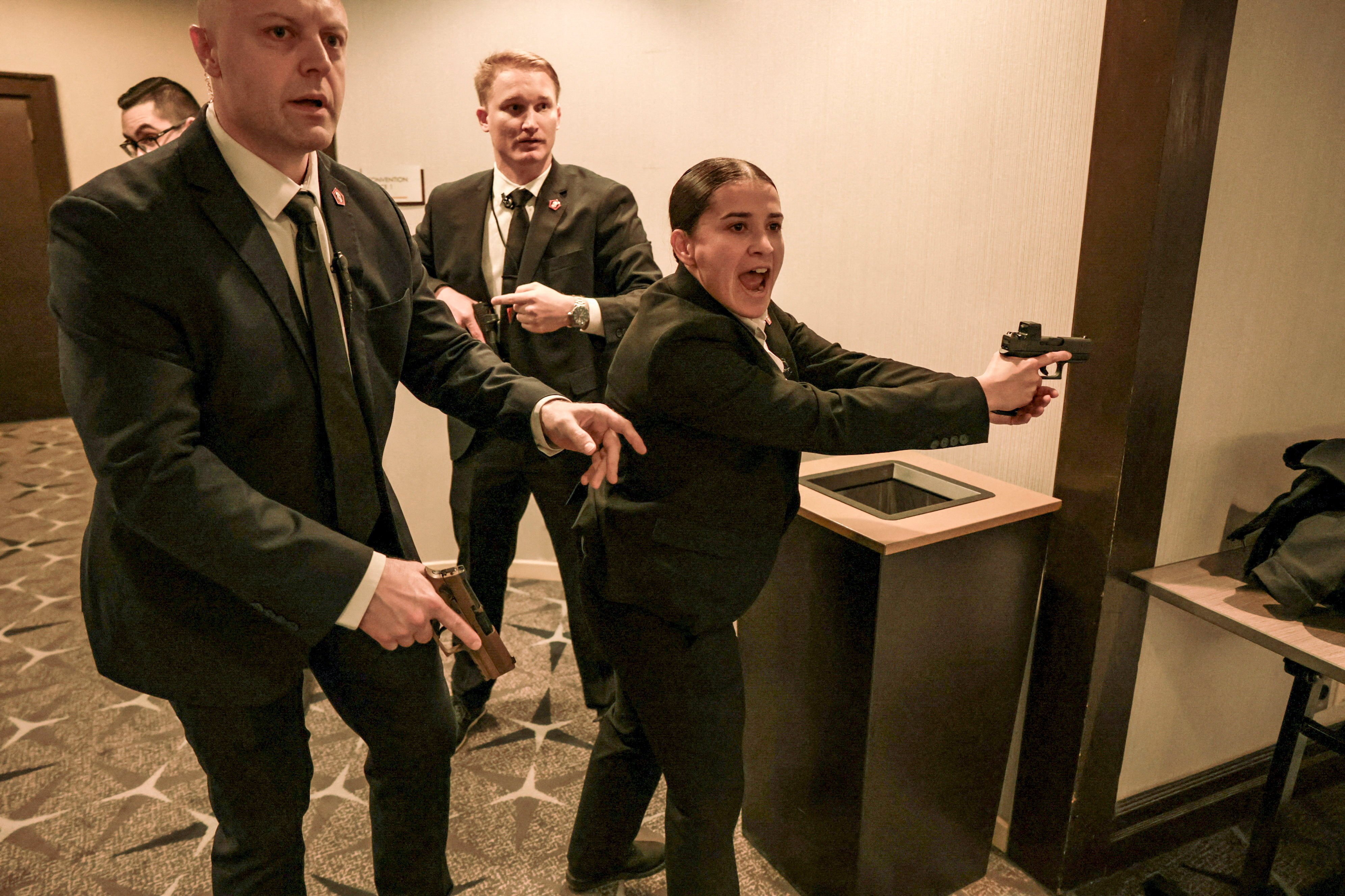Security officials react as a shooter opens fire at the White House Correspondents’ Association dinner, in Washington on April 25. Online commenters showed interest in the female agent’s drawn Glock pistol and what appeared to be a Holosun sight. Photo: Reuters
