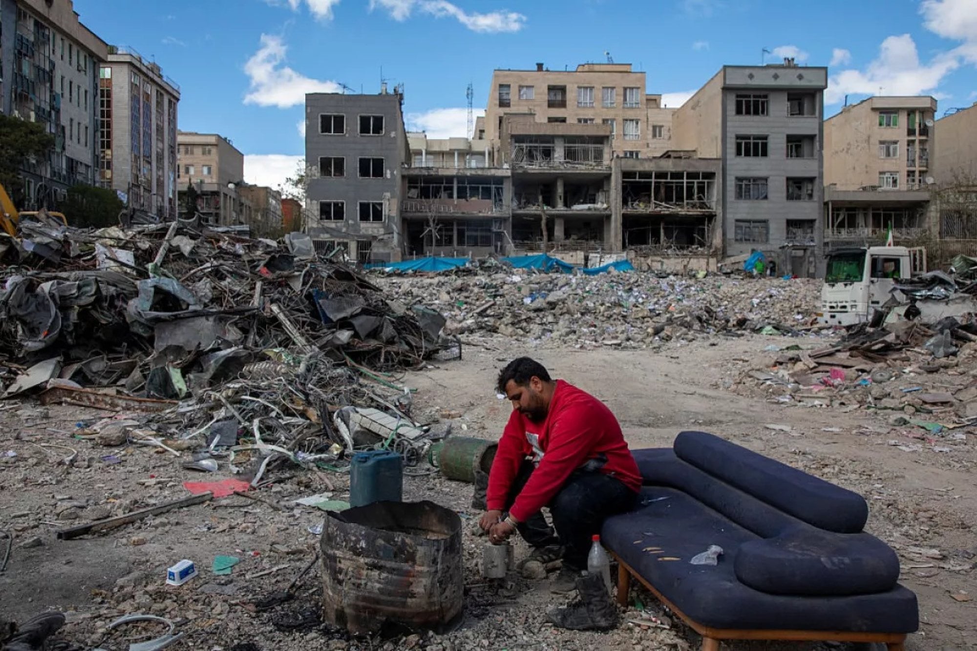 A man sits among buildings destroyed in a joint attack by Israel and the United States on the Iranian capital, Tehran. Photo: Getty Images