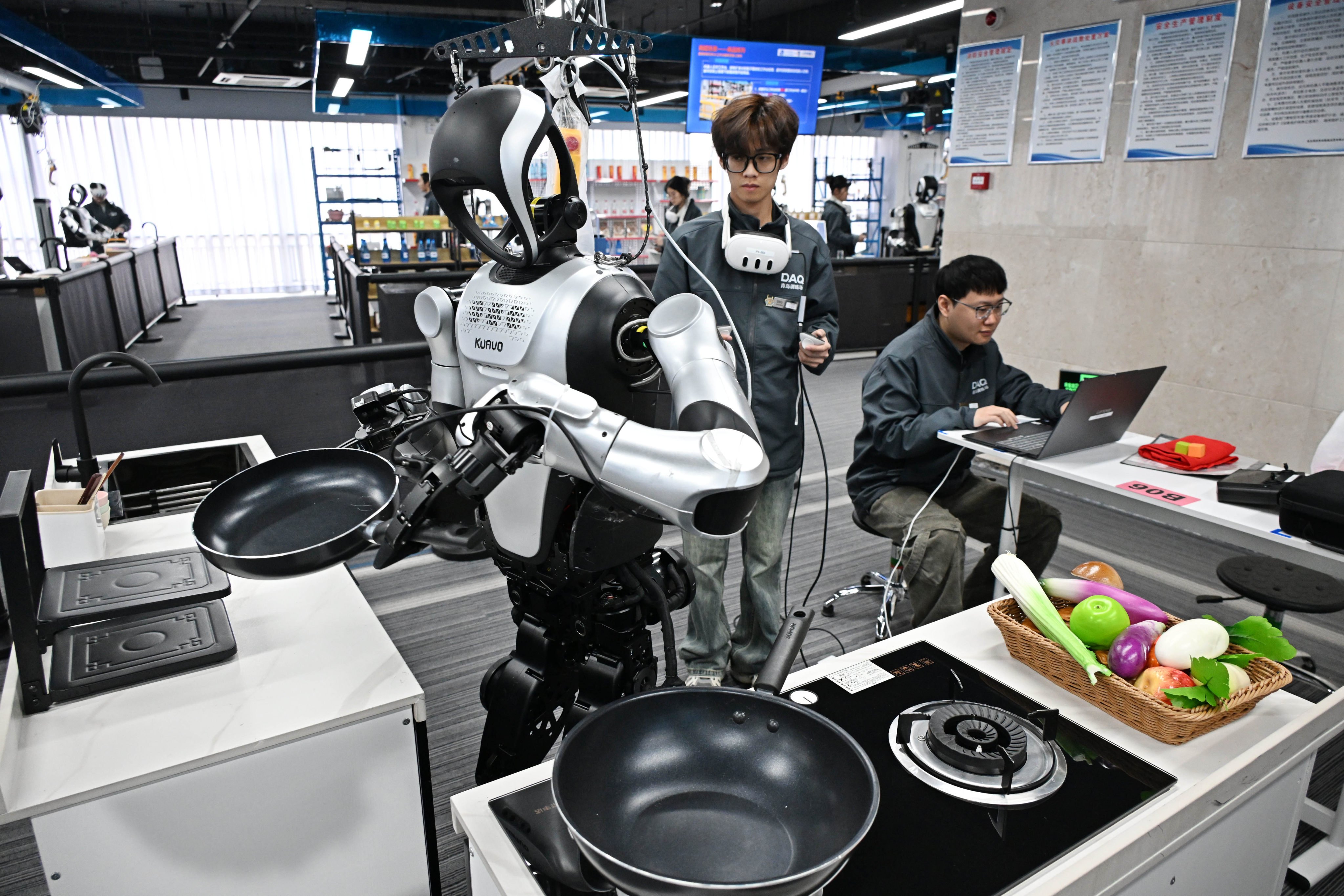 Employees put a robot through its paces at the Qingdao Humanoid Robot Data Training Centre in Qingdao, Shandong province, on March 23. Photo: Xinhua