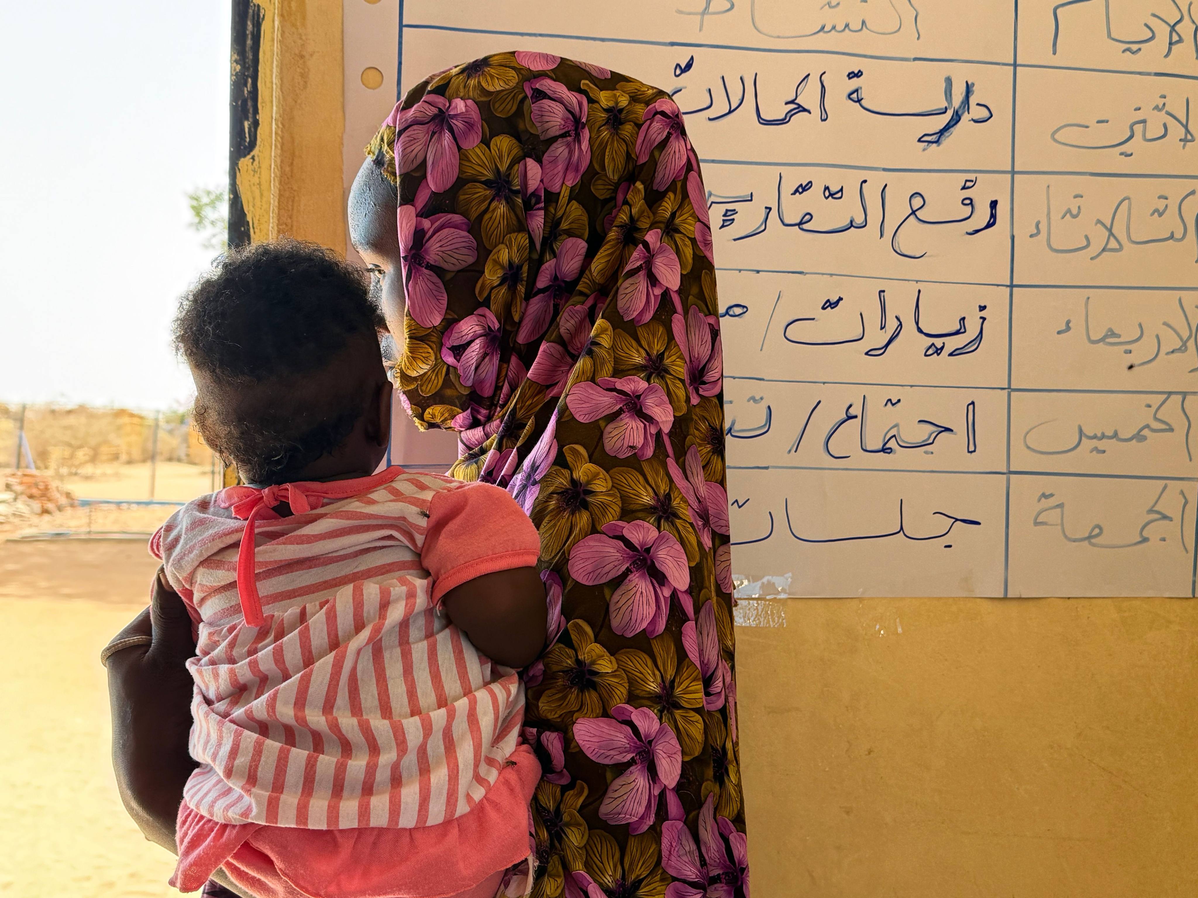A 17-year-old from Sudan holds her child in her arms in a refugee camp in Chad. She became pregnant after being raped outside the refugee camp. Photo: dpa