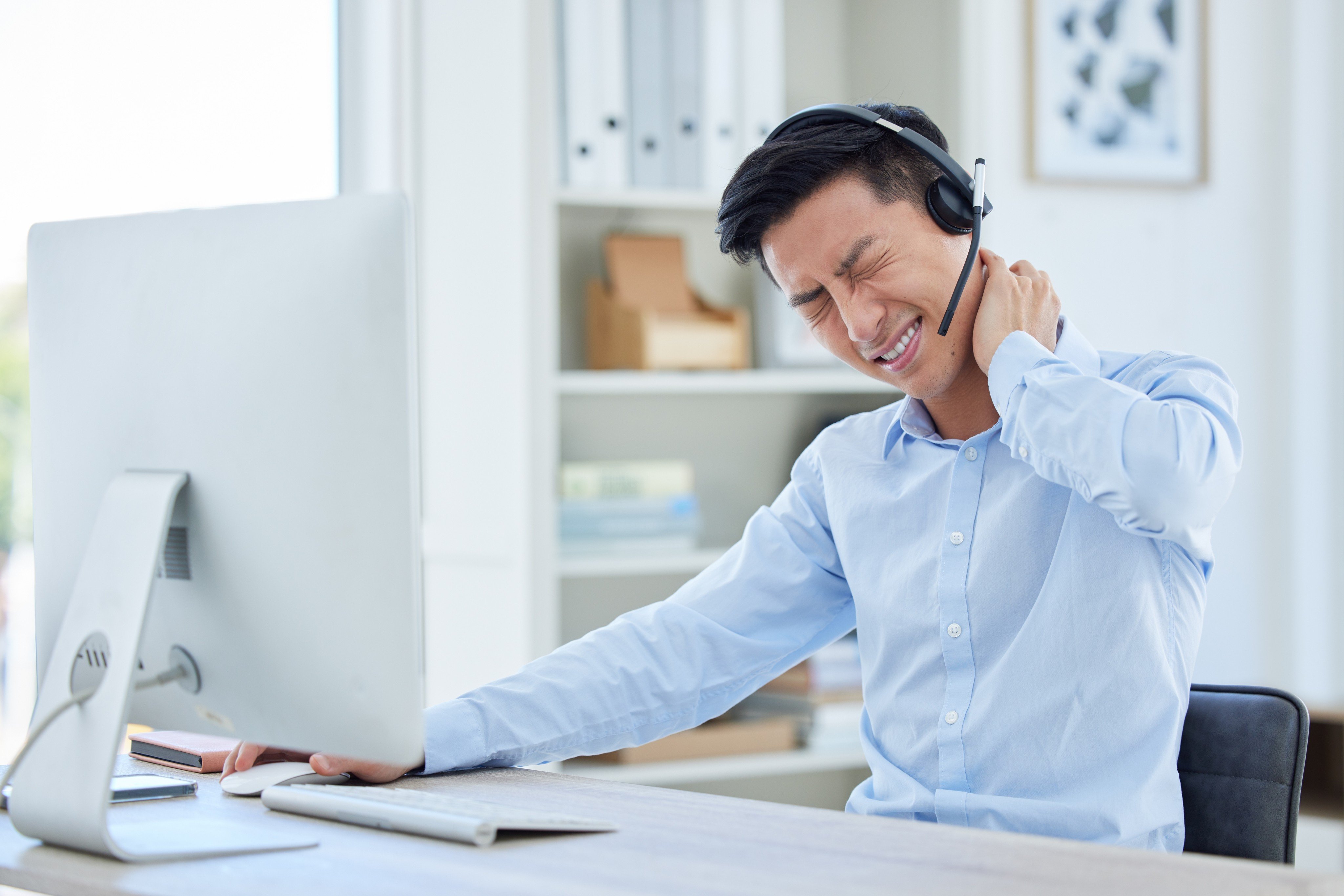 Paying greater attention to posture and adding neck-specific exercises to a fitness routine are small changes that could ease discomfort for office worker who use screens extensively. Photo: Shutterstock