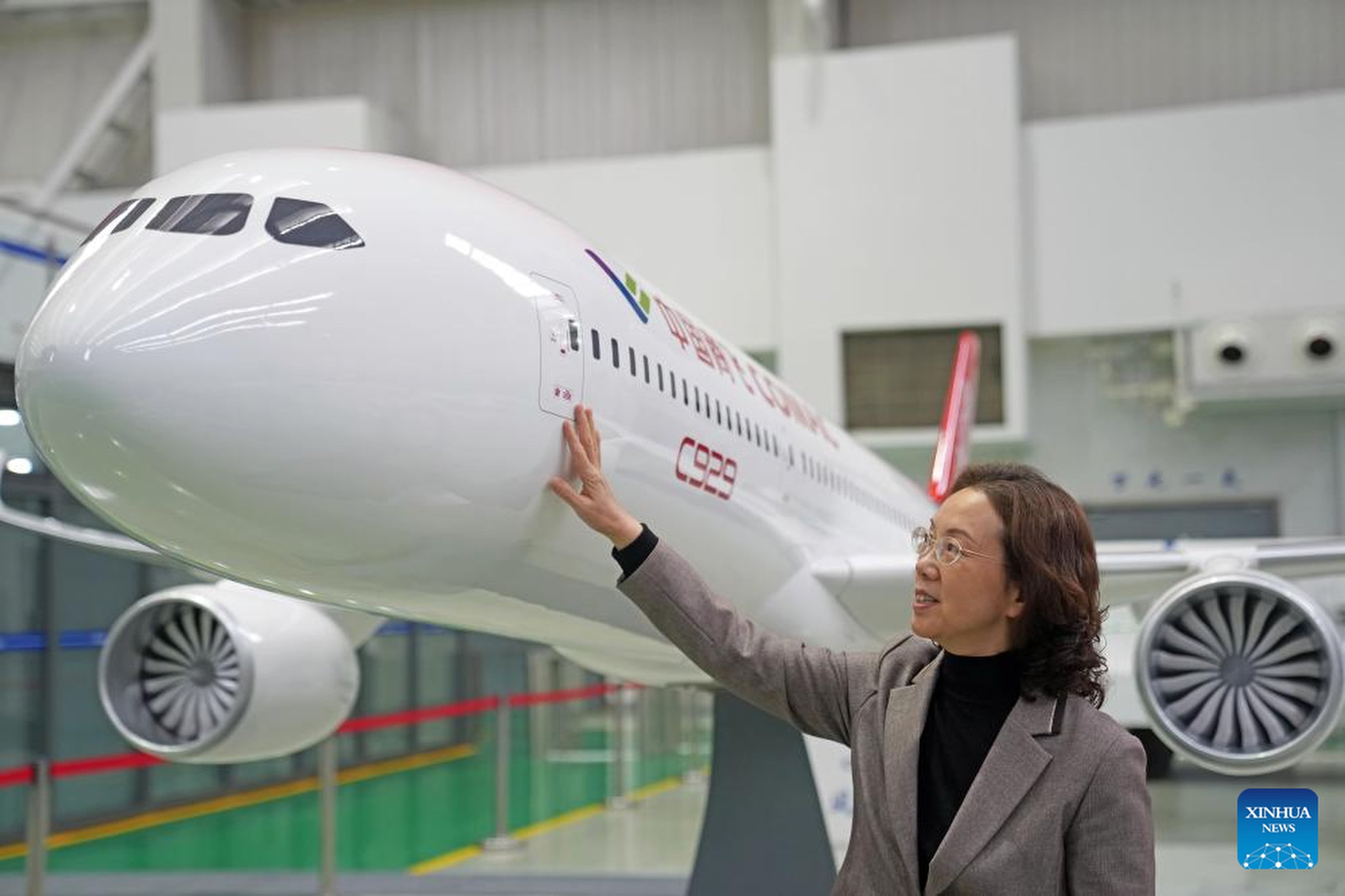 Zhao Chunling, the chief designer of China’s widebody C929 aircraft, touches a model of the in-development jet. Photo: Xinhua