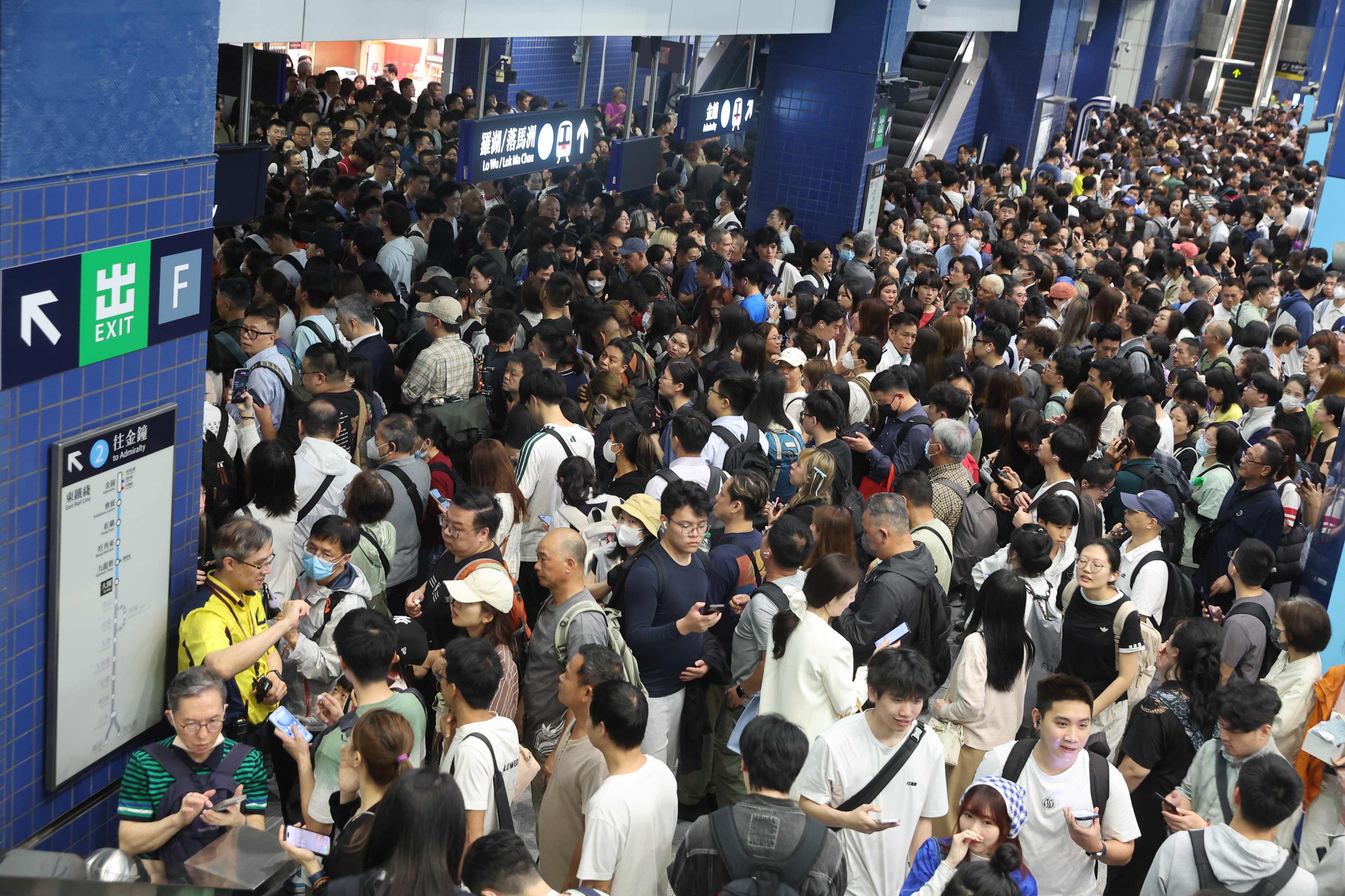 Stranded passengers wait at Tai Wai Station following a suspension of MTR services after a man opened the emergency exit ramp on a train travelling from Kowloon Tong to Tai Wai station. Photo: Edmond So
