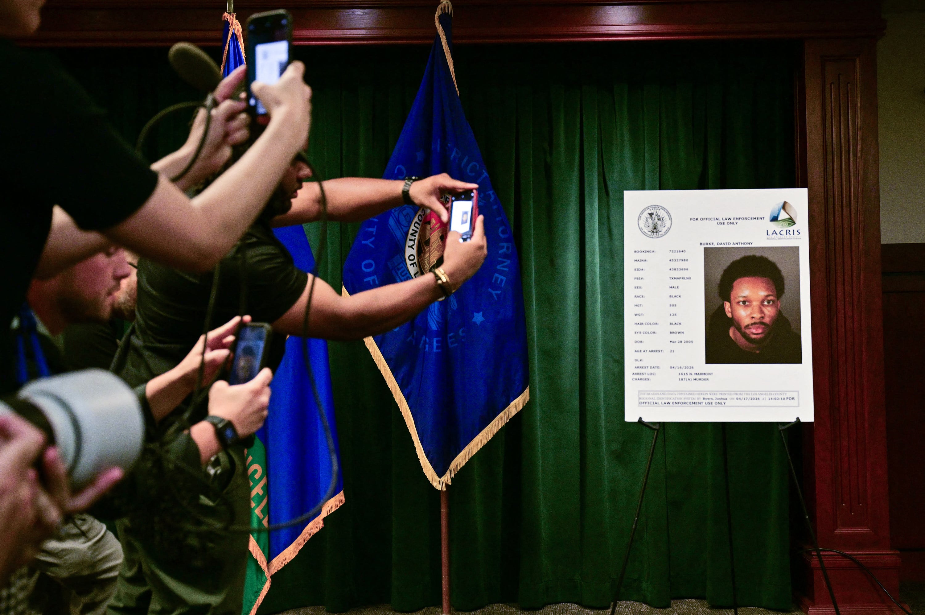 Journalists take pictures of a booking photo of David Burke, known as D4vd. Photo: AP