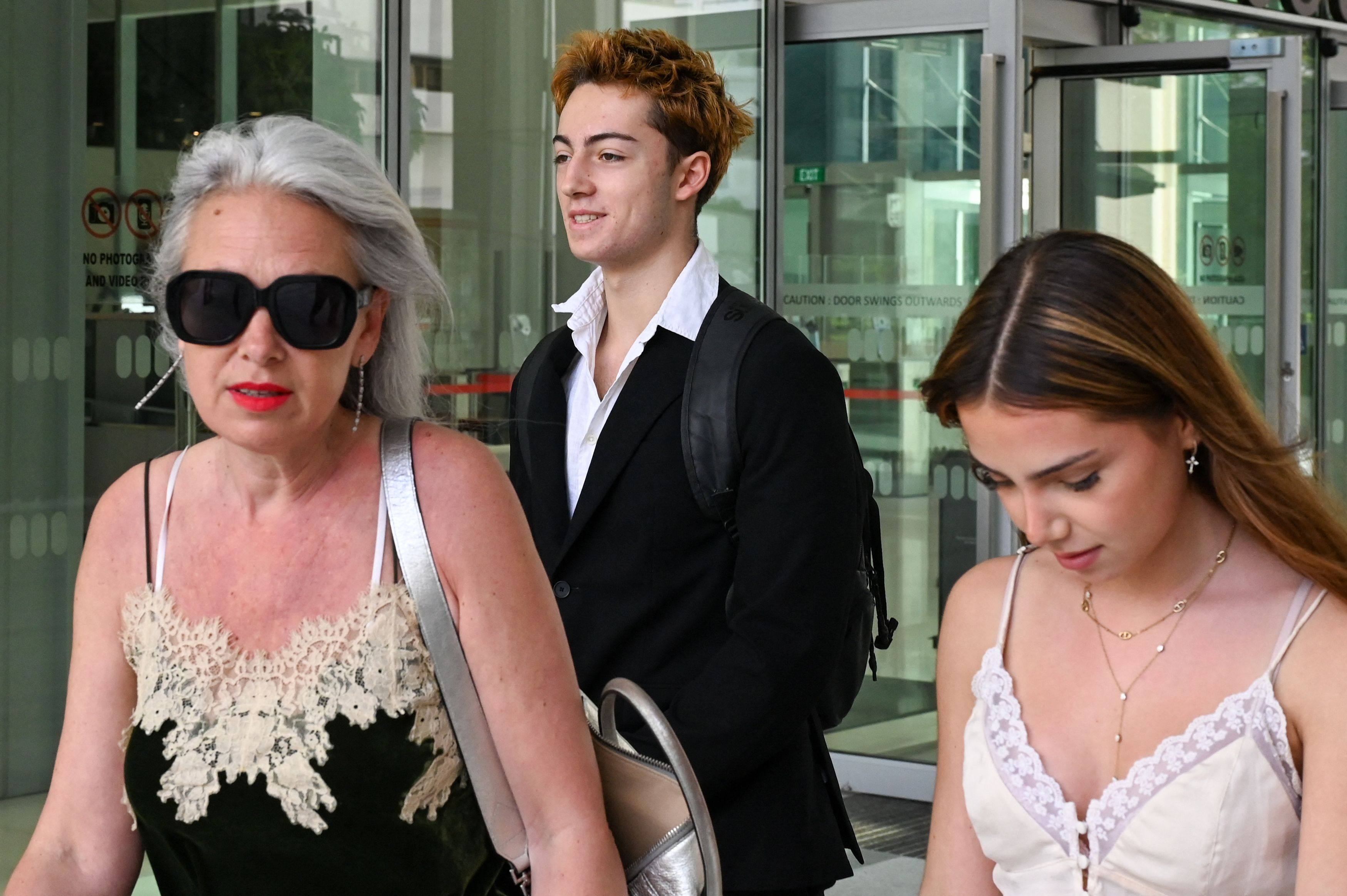 French teenager Didier Gaspard Owen Maximilien (centre) leaves the State Courts in Singapore on Wednesday. Photo: AFP