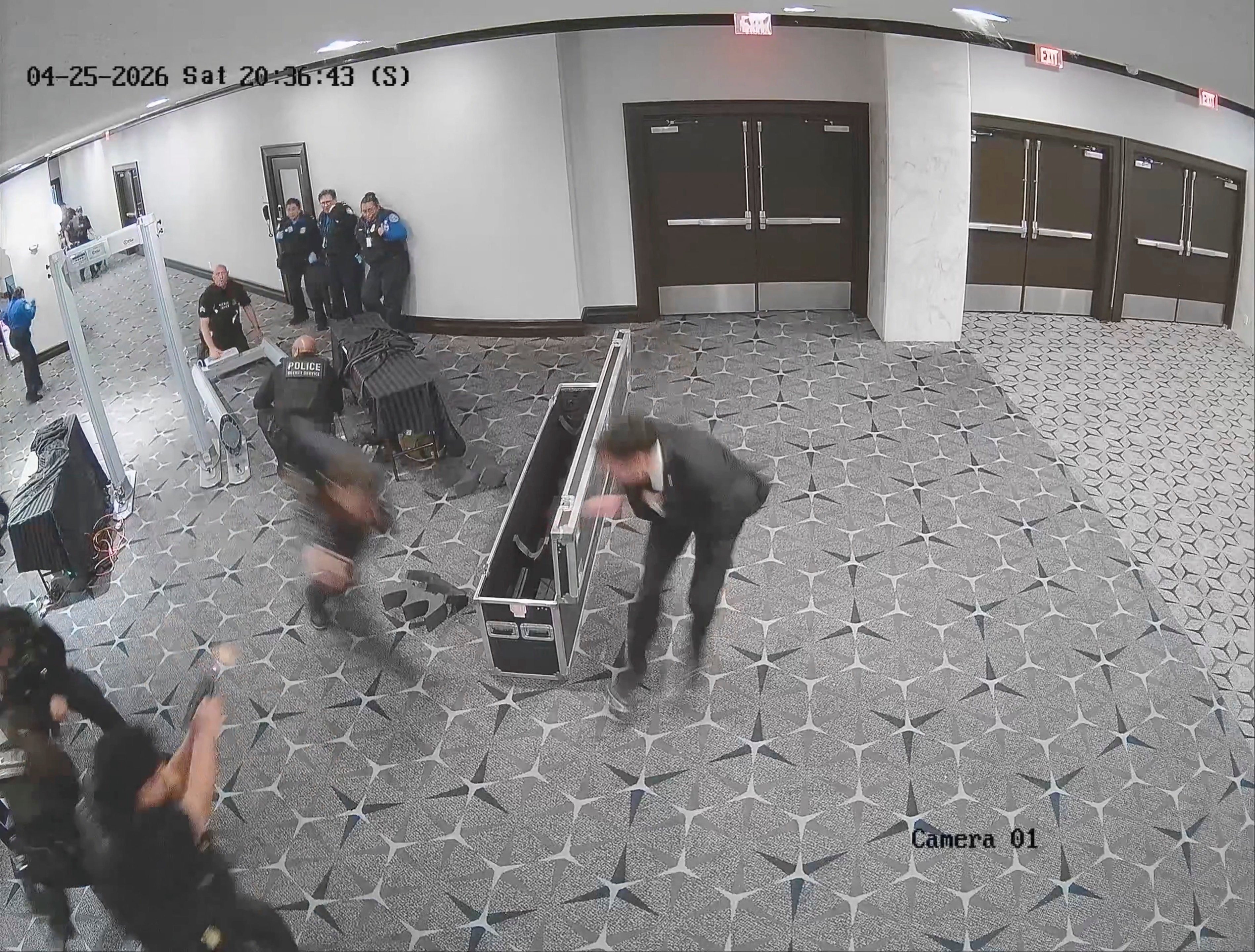 An officer fires (bottom left) as suspect Cole Tomas Allen sprints past security personnel at the Washington Hilton on Saturday. Photo: US Attorney Jeanine Pirro via Reuters