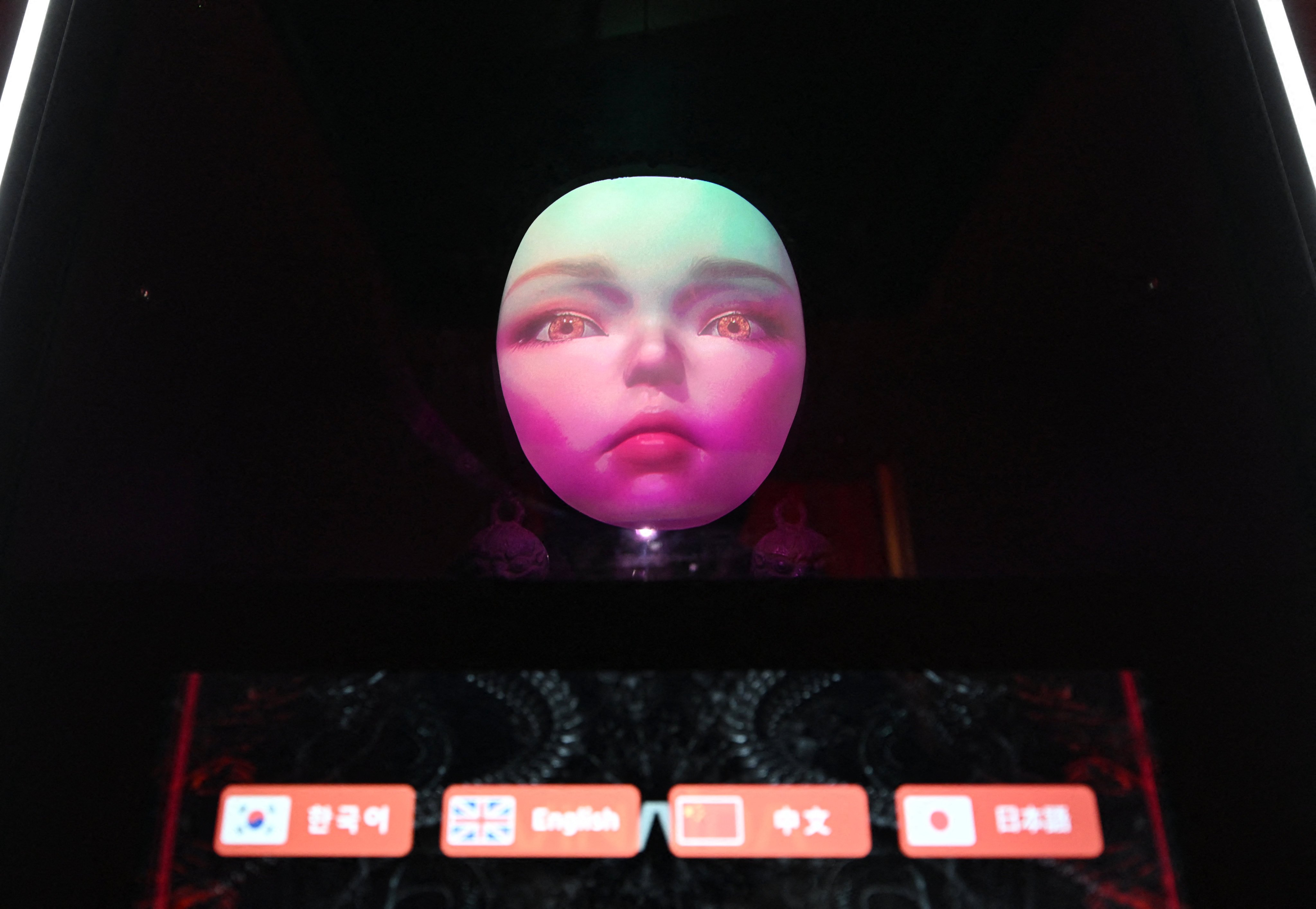 This picture taken on April 15, 2026 shows an artificial intelligence-assisted shaman robot on display in a machine that can read visitors’ fortunes at a Korean shamanism theme shop in Seoul. The sound of tinkling bells drifts through an alley in central Seoul -- an unmistakable sign that a shaman is near, though in this case the mystic is a robot powered by artificial intelligence. (Photo by Jung Yeon-je / AFP) / TO GO WITH AFP STORY  SKorea-AI-religion-shaman / REPORTAGE BY Kang Jin-kyu