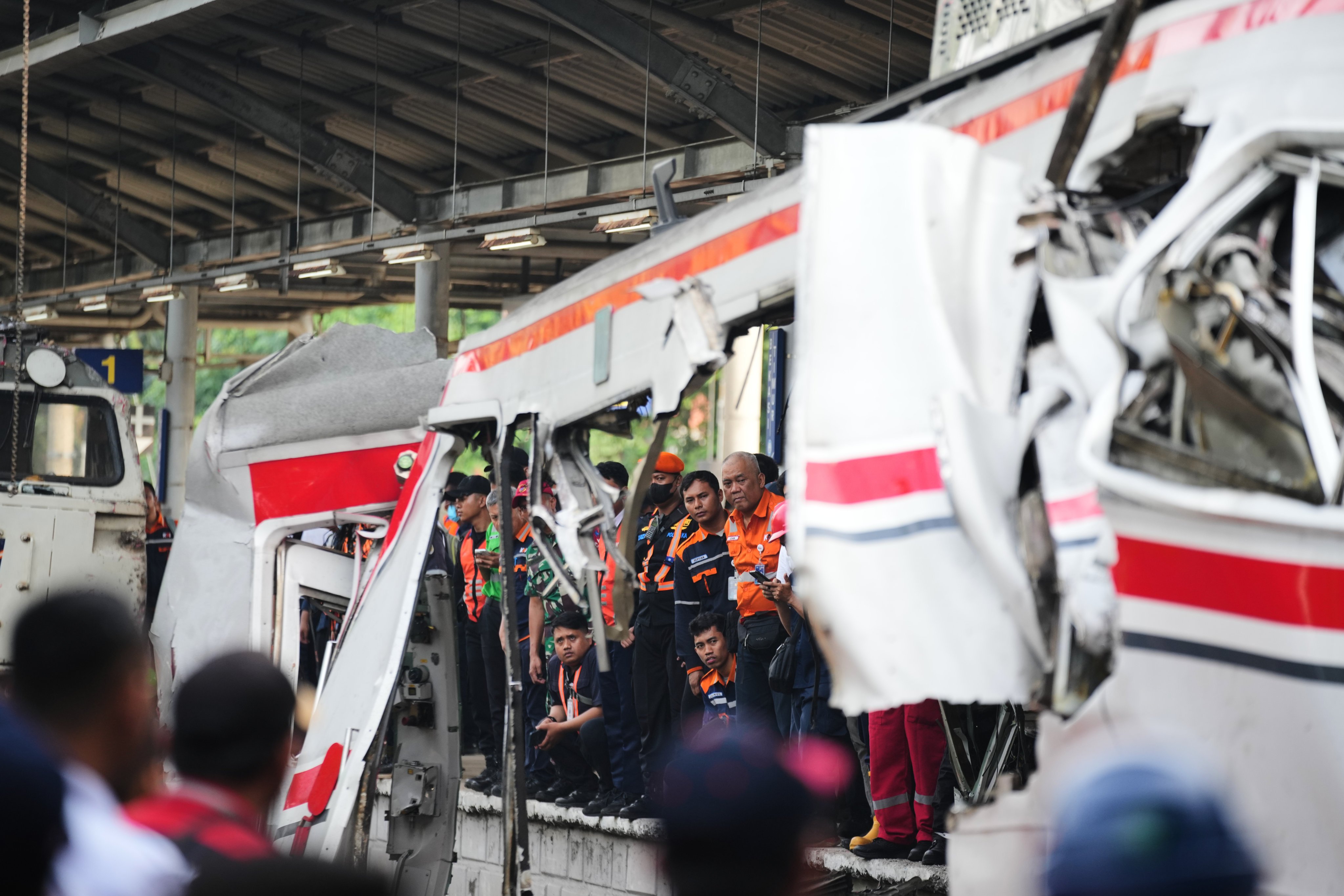 Workers and rescuers on Tuesday examine the wreckage following a train collision in Bekasi, Indonesia. Photo: AP