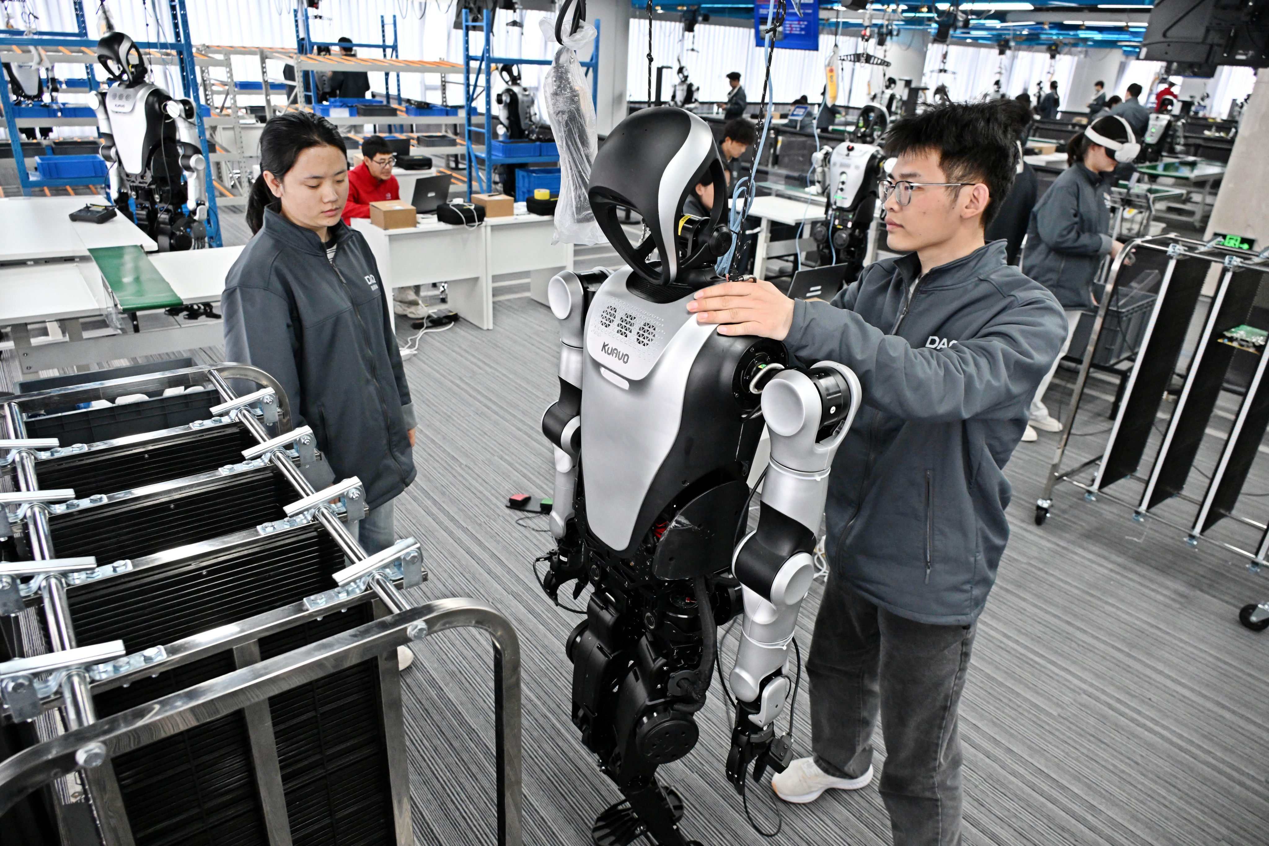 Trainers supervise the training of a humanoid robot at the Qingdao Humanoid Robot Data and Training Centre in Qingdao, east China’s Shandong Province. Photo: Xinhua