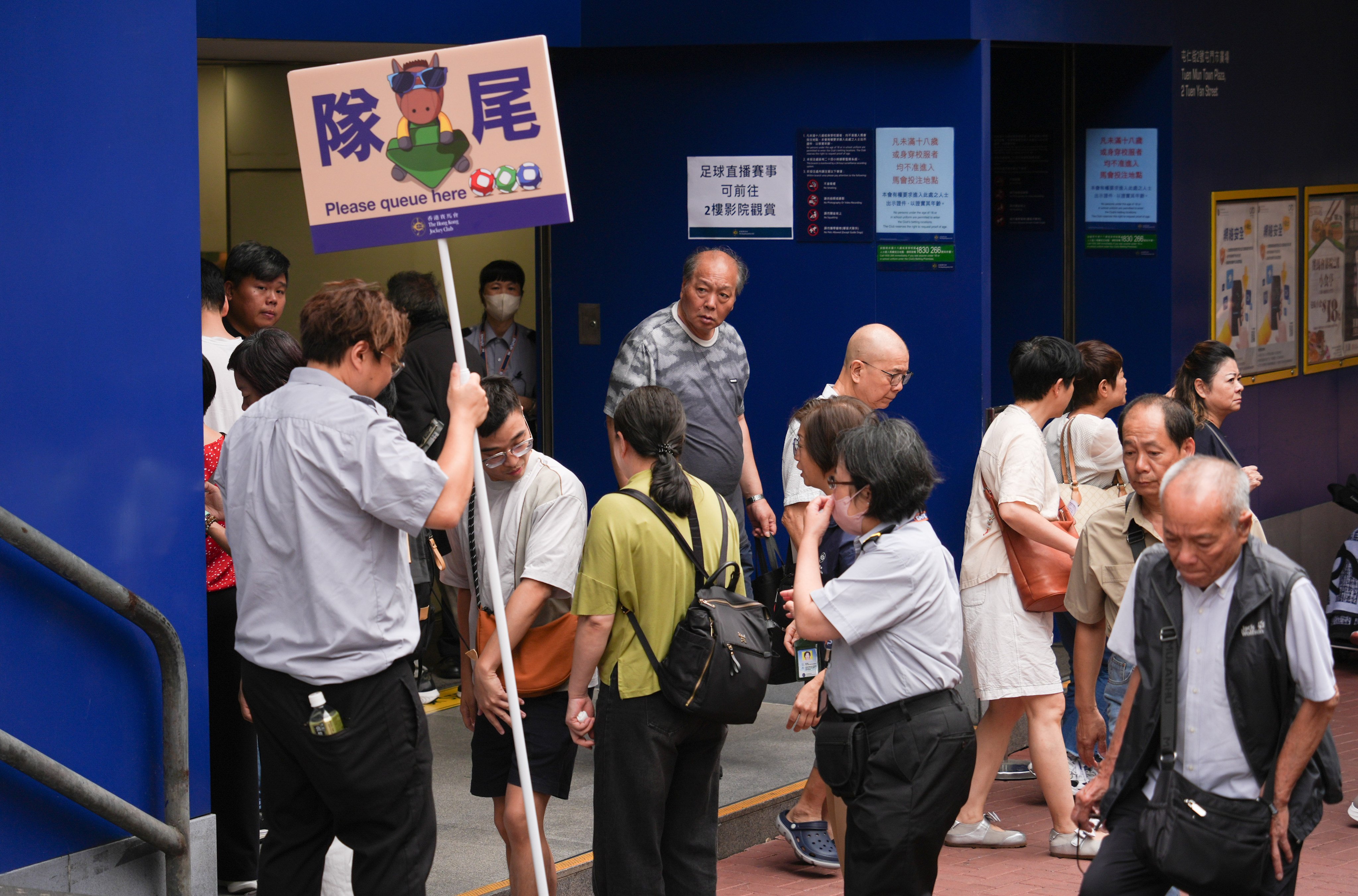 Residents queue up to buy Mark Six tickets on Saturday. Photo: Eugene Lee