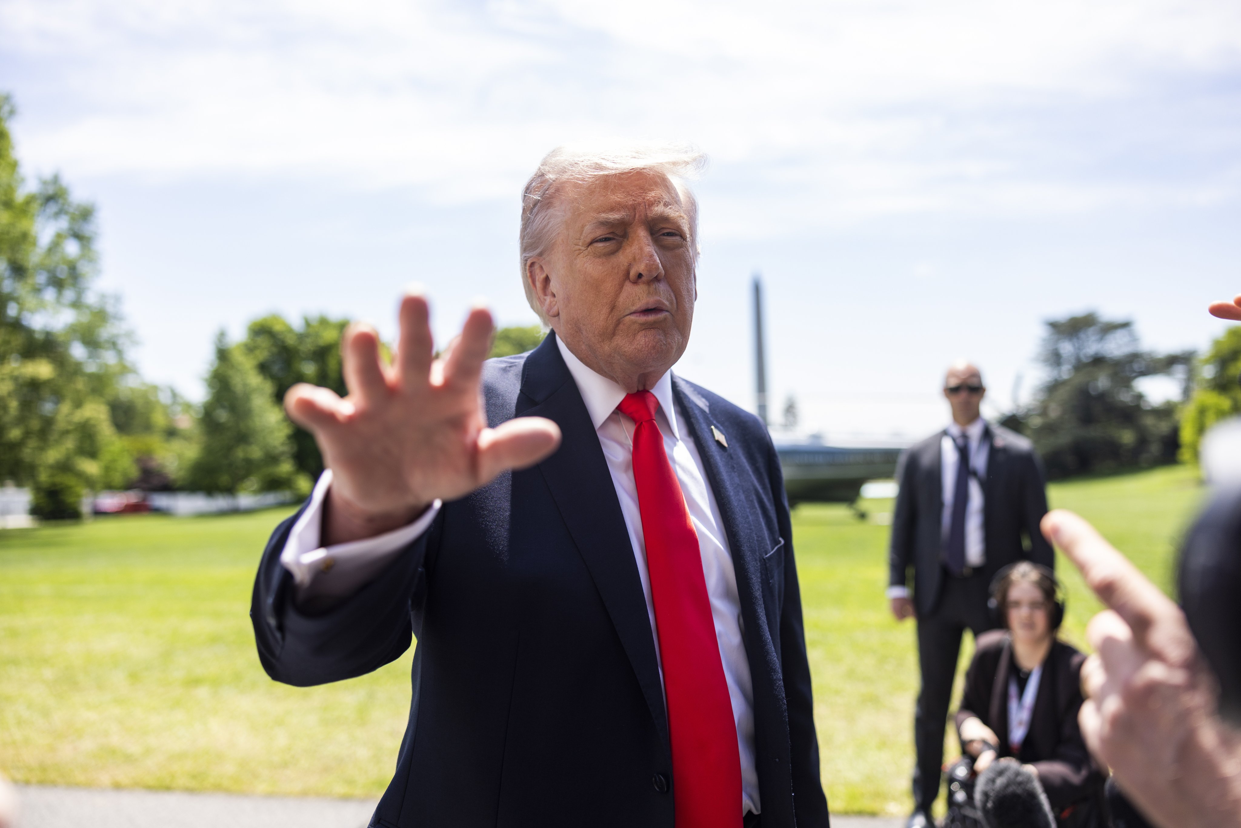 US President Donald Trump stops to speak to reporters before boarding Marine One on Friday. Photo: pool via EPA