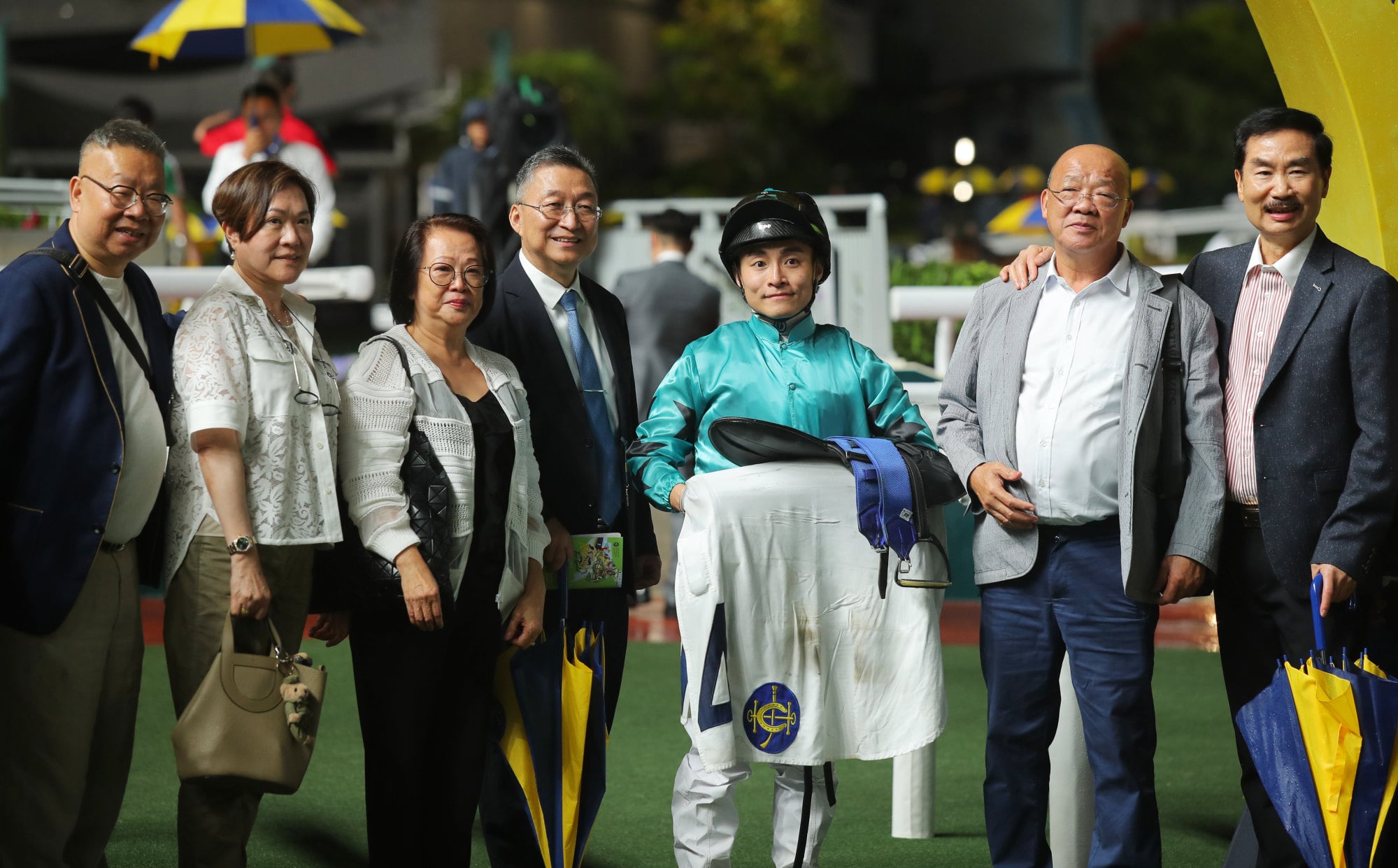 Trainer Francis Lui (centre), jockey Keith Yeung and connections of Turquoise Velocity celebrate his win.