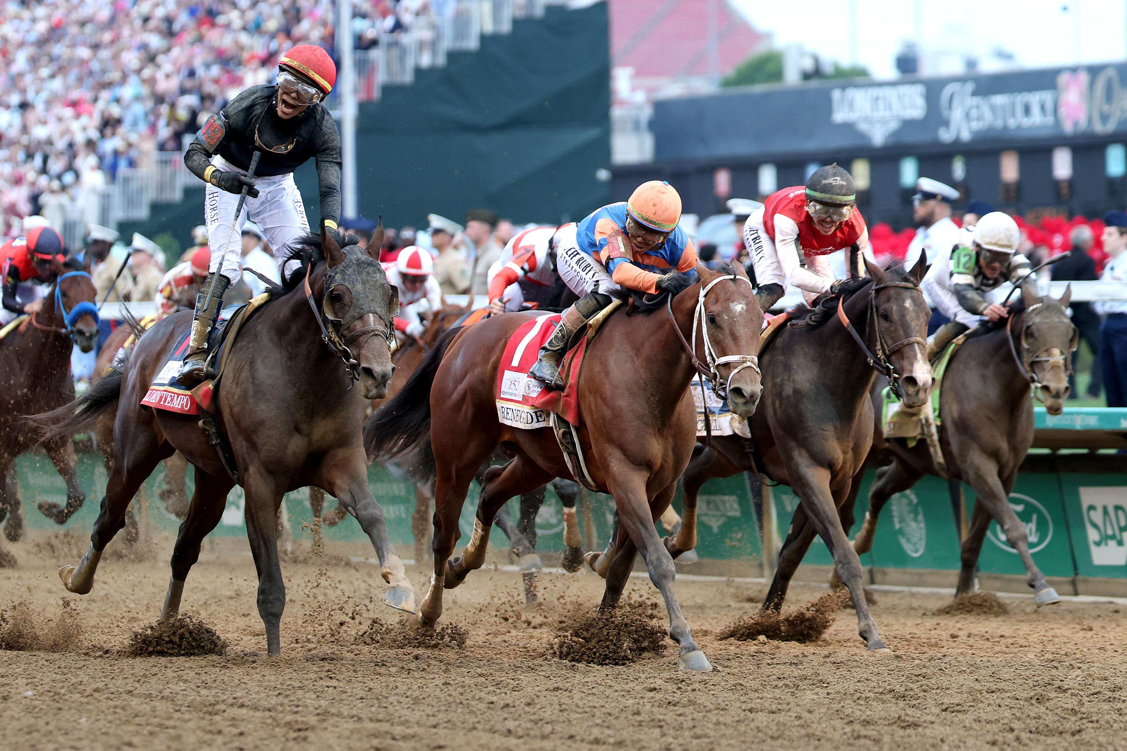 Golden Tempo (left), ridden by jockey Jose Ortiz, crosses the finish line to win the 152nd Kentucky Derby. Photo: Getty Images