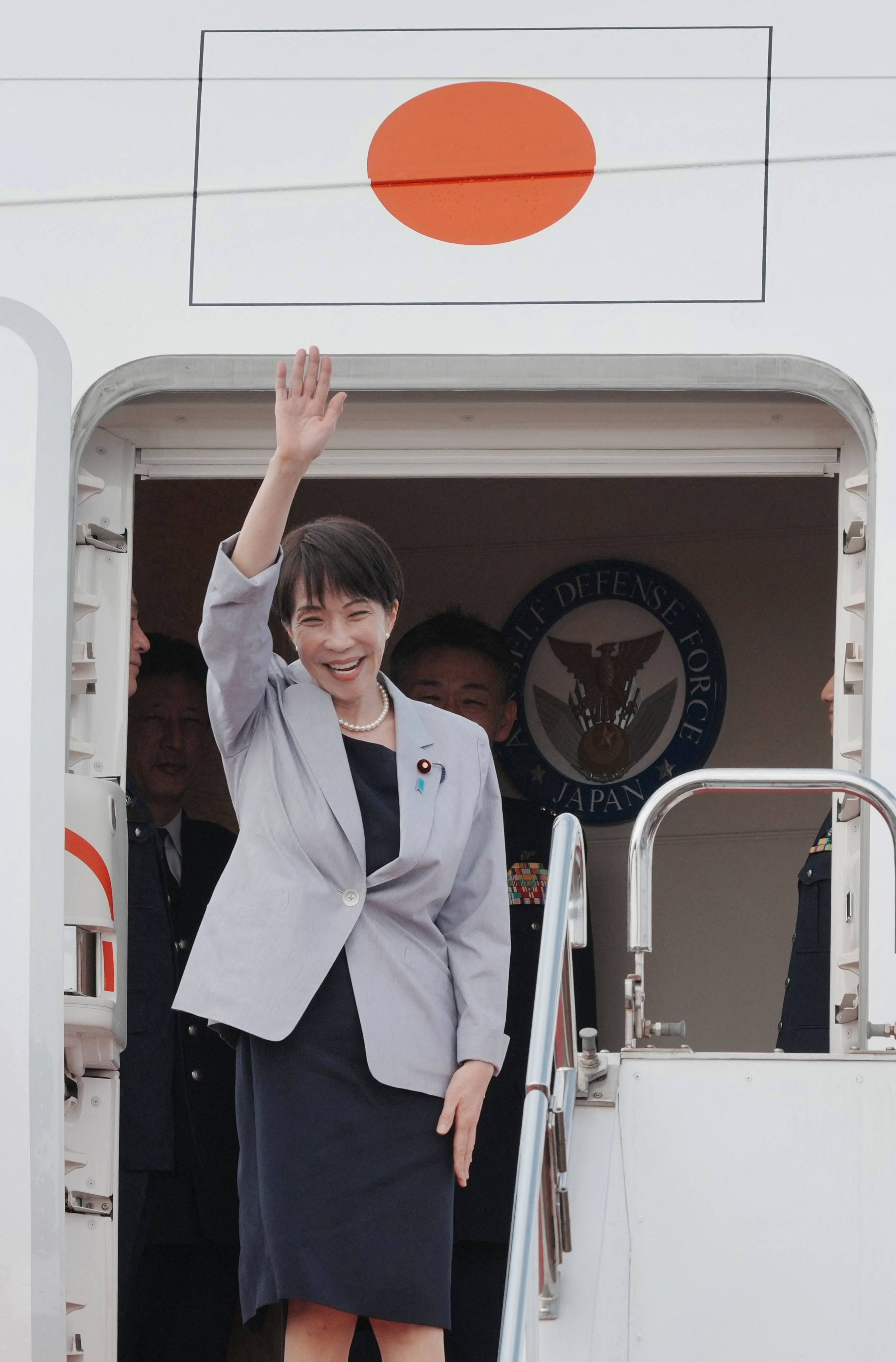 Japan’s Prime Minister Sanae Takaichi waves as she departs on an official trip to Vietnam and Australia, at Haneda Airport in Tokyo on Friday. Photo: AFP