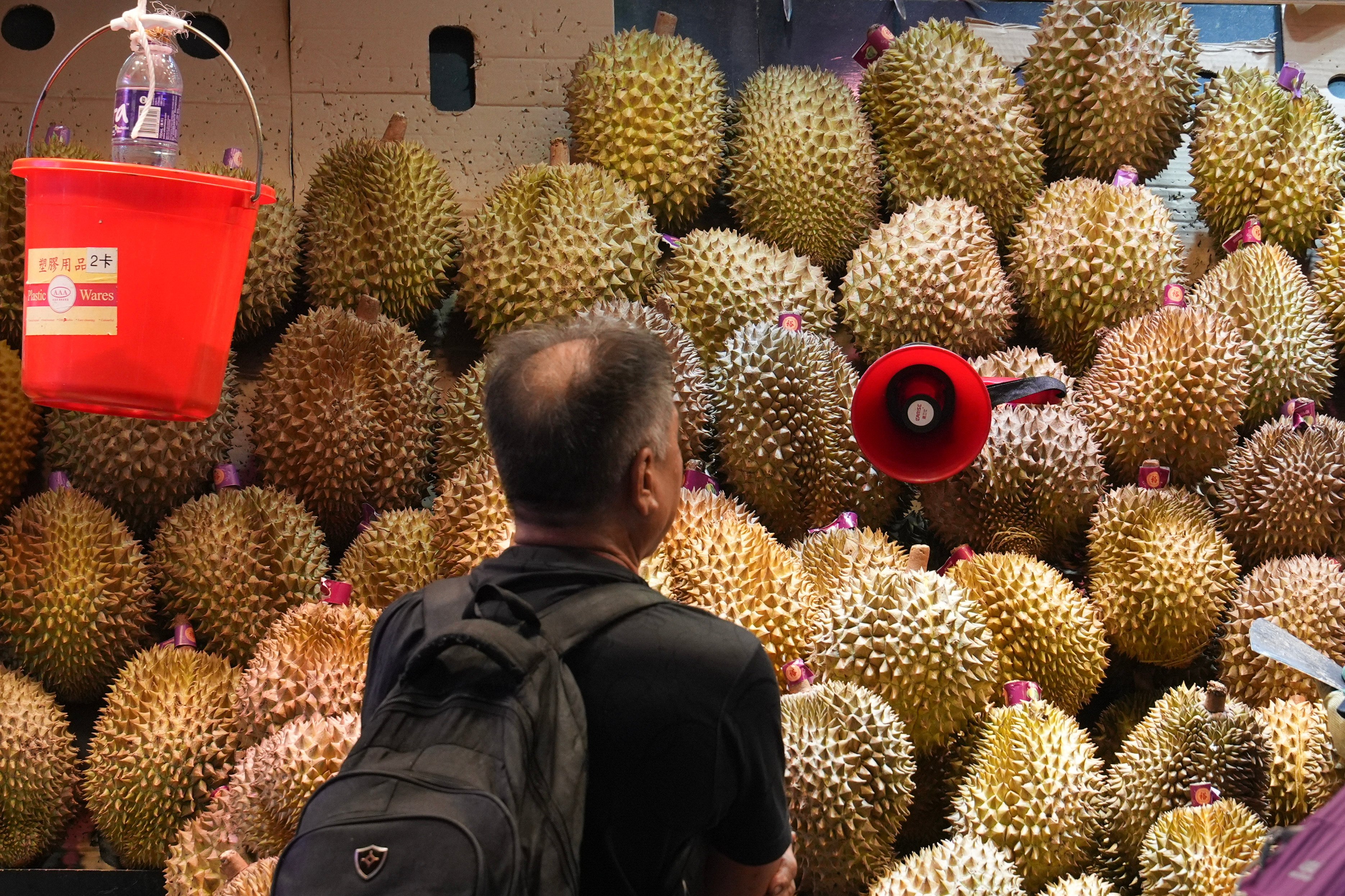 A shopper browses a mound of durians at a market in Hong Kong. Photo: Eugene Lee