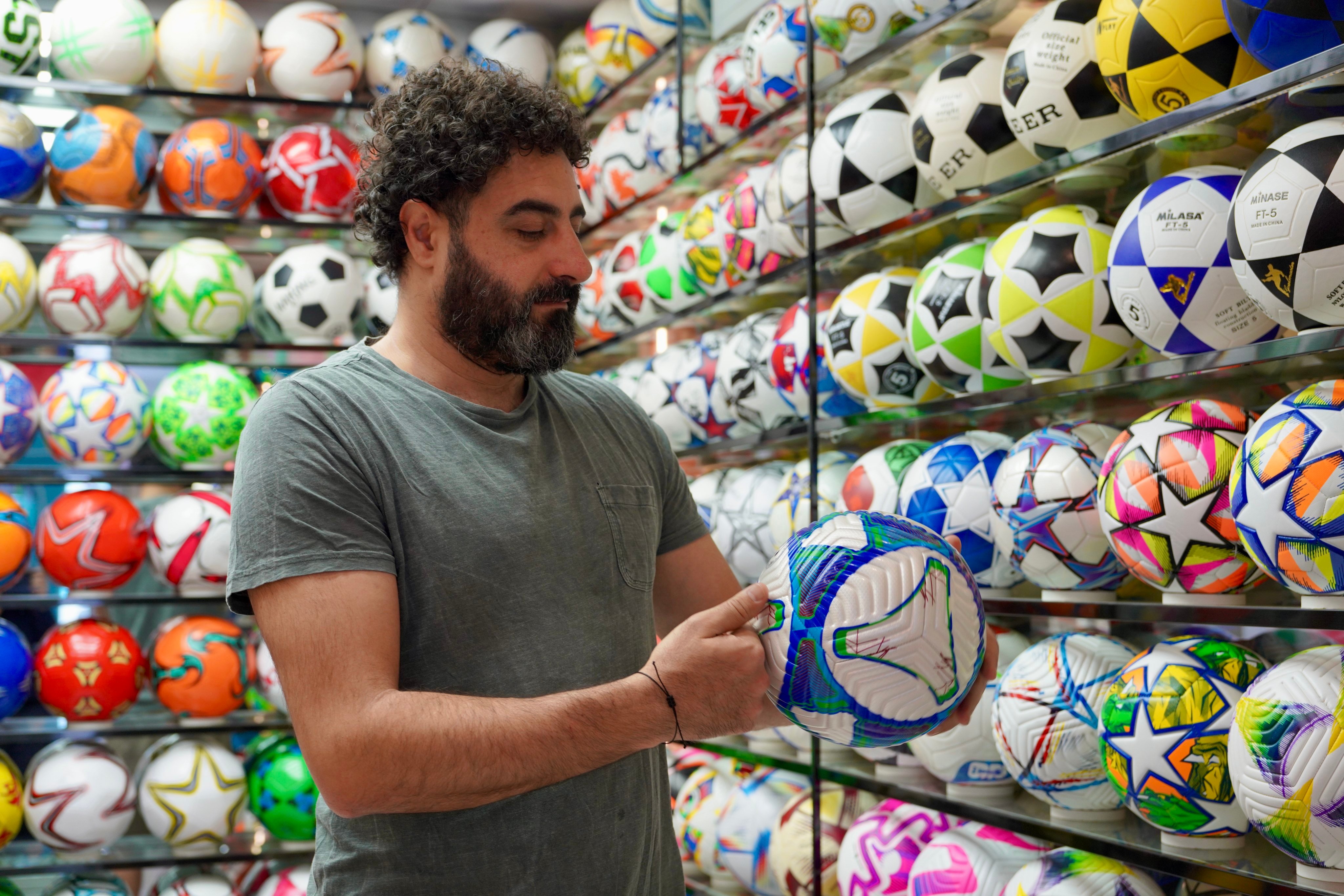 A foreign buyer checks footballs at a store in Yiwu, Zhejiang province, ahead of the 2026 FIFA World Cup. Photo: China News Service/VCG via Getty Images