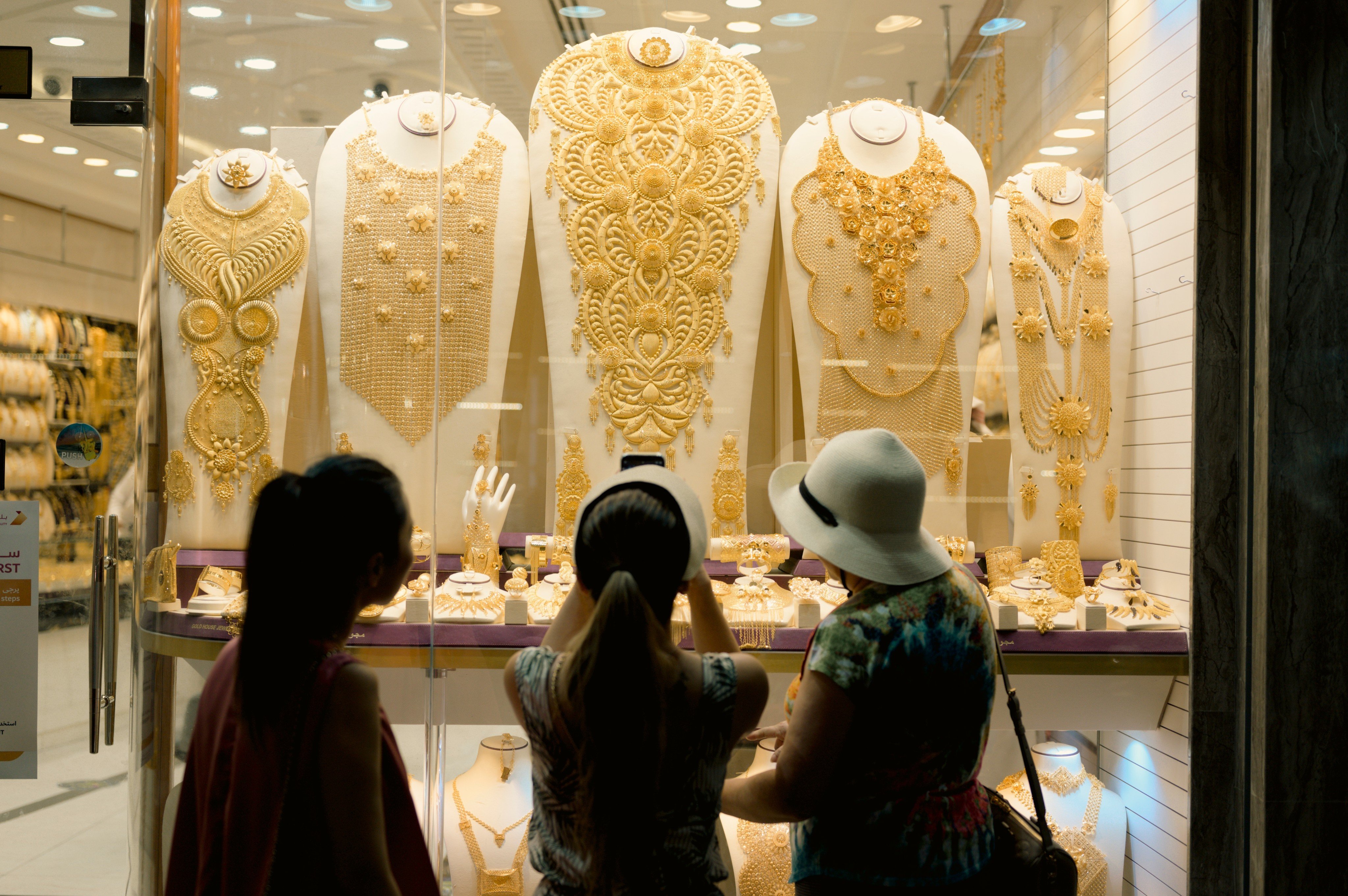 Tourists admire gold jewellery at the Gold Souq in Dubai. Photo: Shutterstock