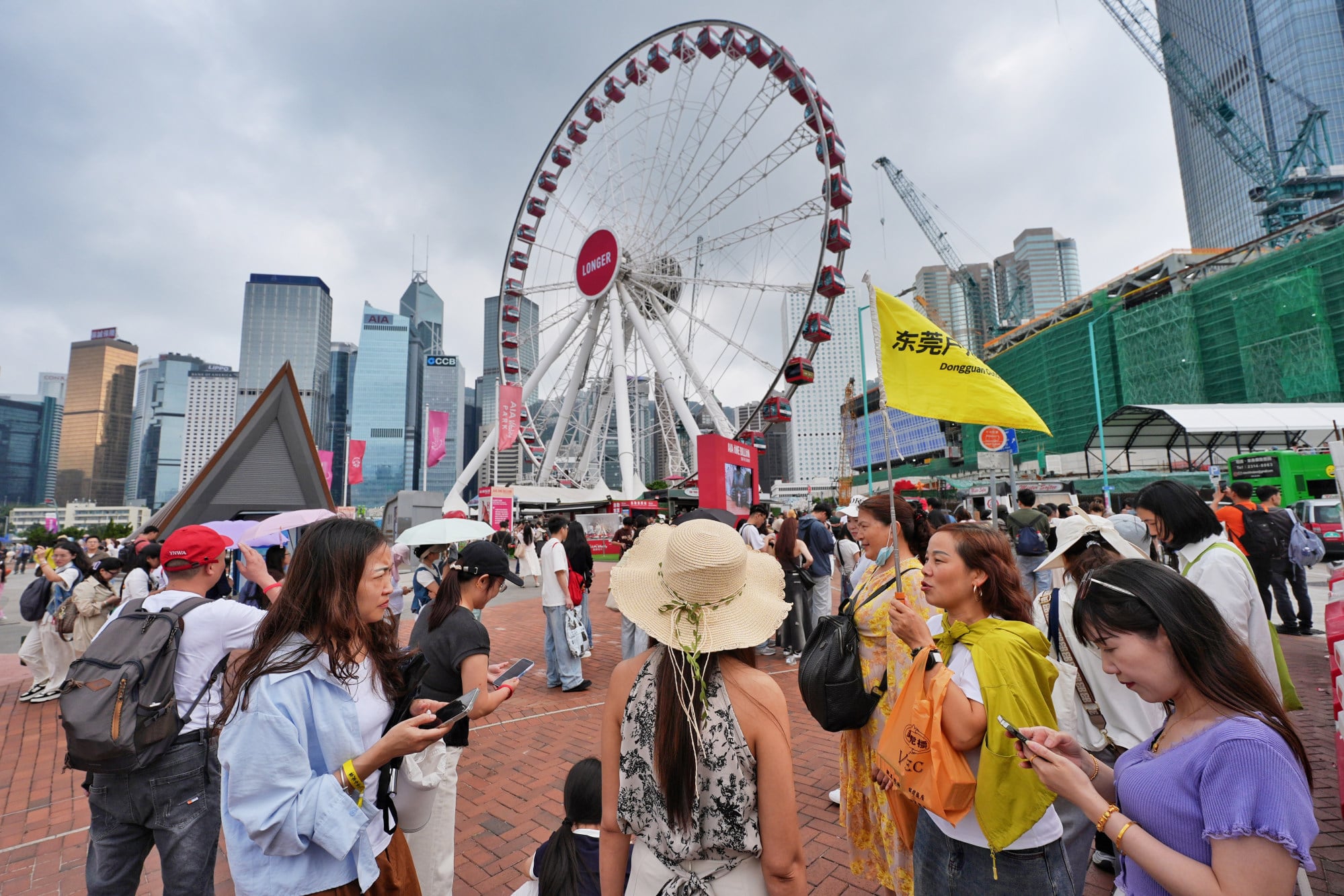 Visitors at the Central Harbourfront. The Travel Industry Council estimates that about 900 tour groups involving 30,000 travellers will visit the city during the holiday. Photo: Elson Li
