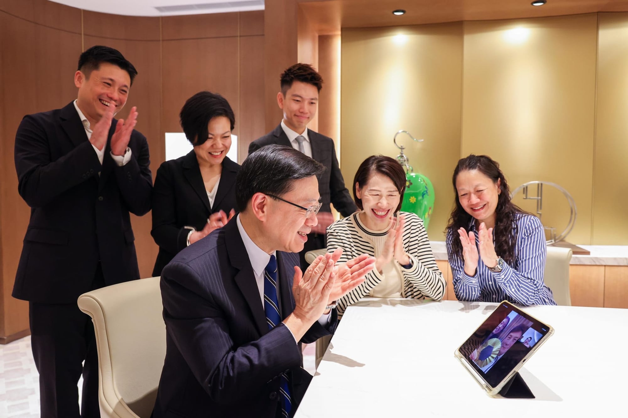John Tse (far left) joins Chief Executive John Lee in calling Vivian Kong to congratulate her on winning Hong Kong’s first gold medal at the Paris Olympics. Photo: Handout