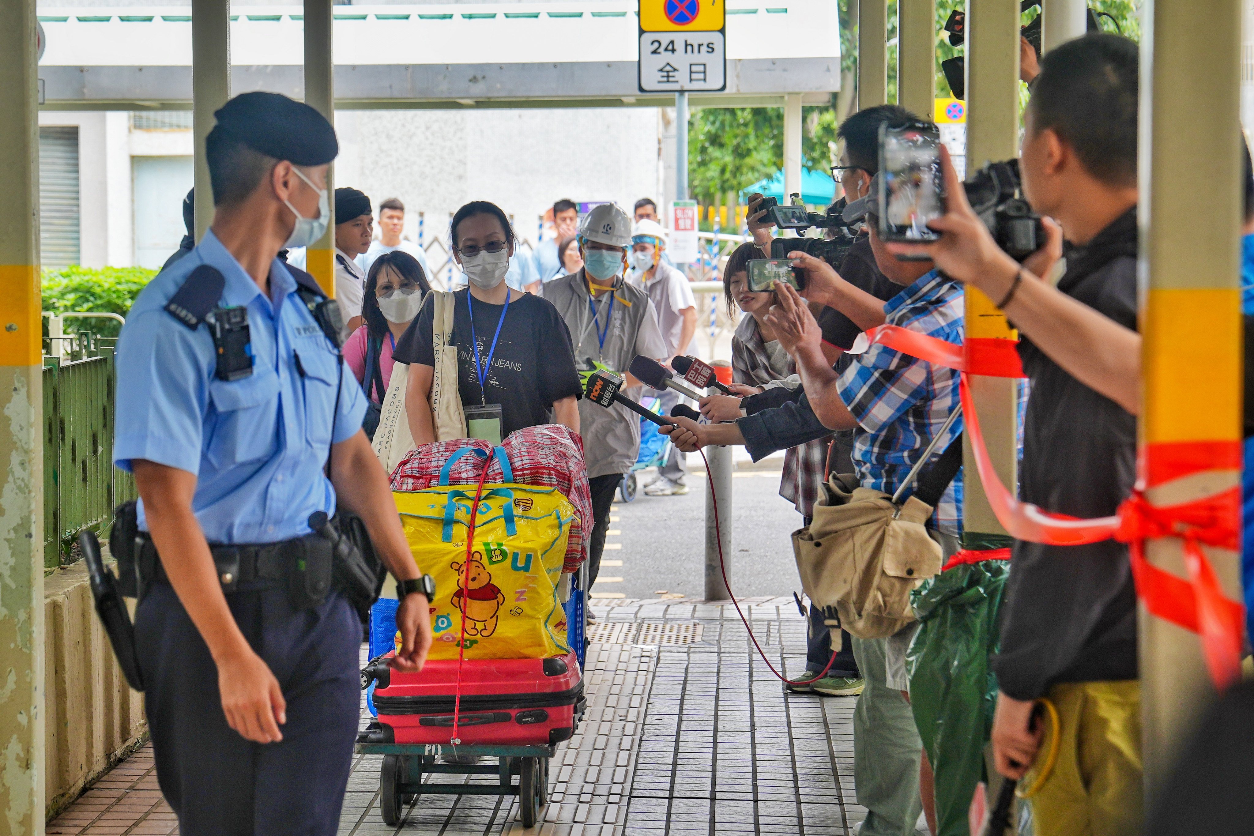 Residents of fire-ravaged Wang Tai House and Wang Kin House and their companions return to their units to salvage their belongings. Pictured in Wang Fuk Court in Tai Po. 30APR26 SCMP / Elson Li