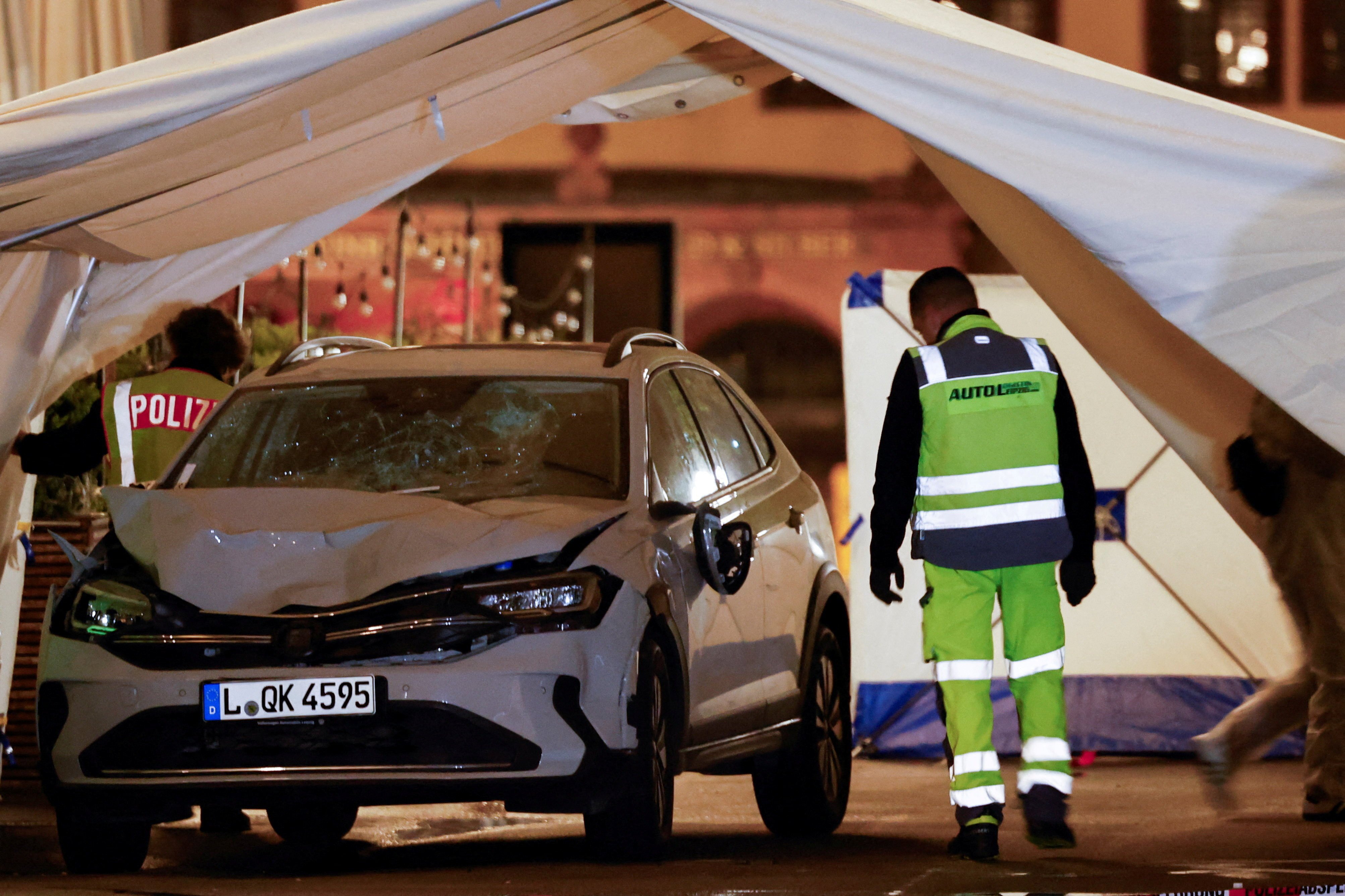Photos from the scene show a car with a battered front and a shattered windshield. Photo: Reuters
