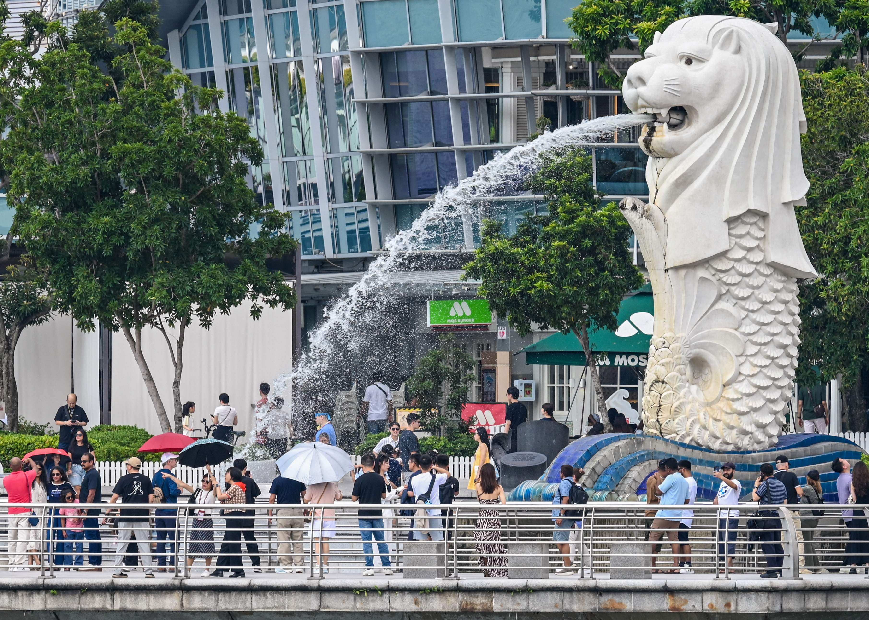 People visit the Merlion statue on the Marina Bay waterfront in Singapore on Tuesday. Photo: AFP