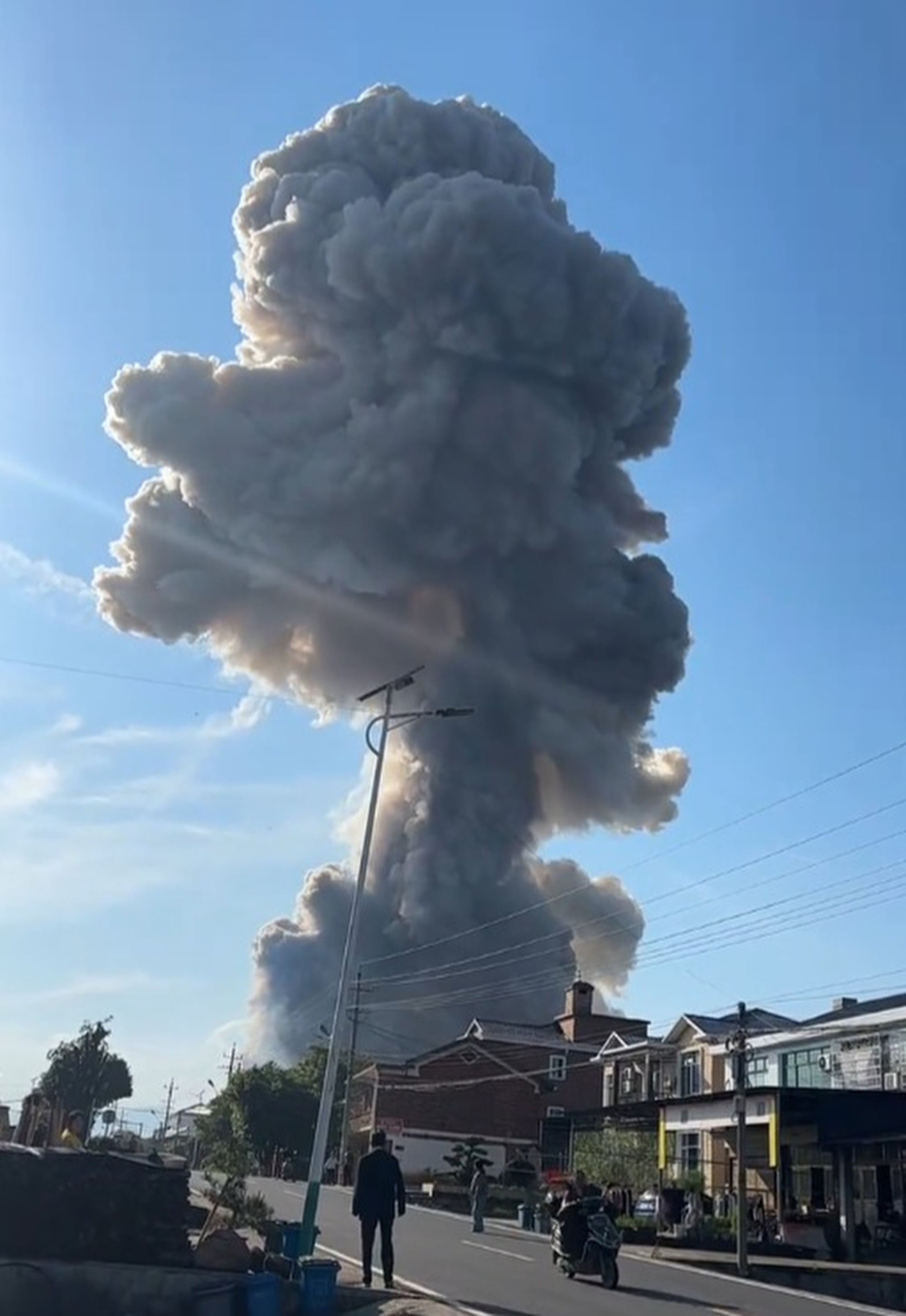 A plume of smoke can be seen in the aftermath of the fireworks factory explosion in Liuyang, Hunan province on Monday. Photo: CCTV