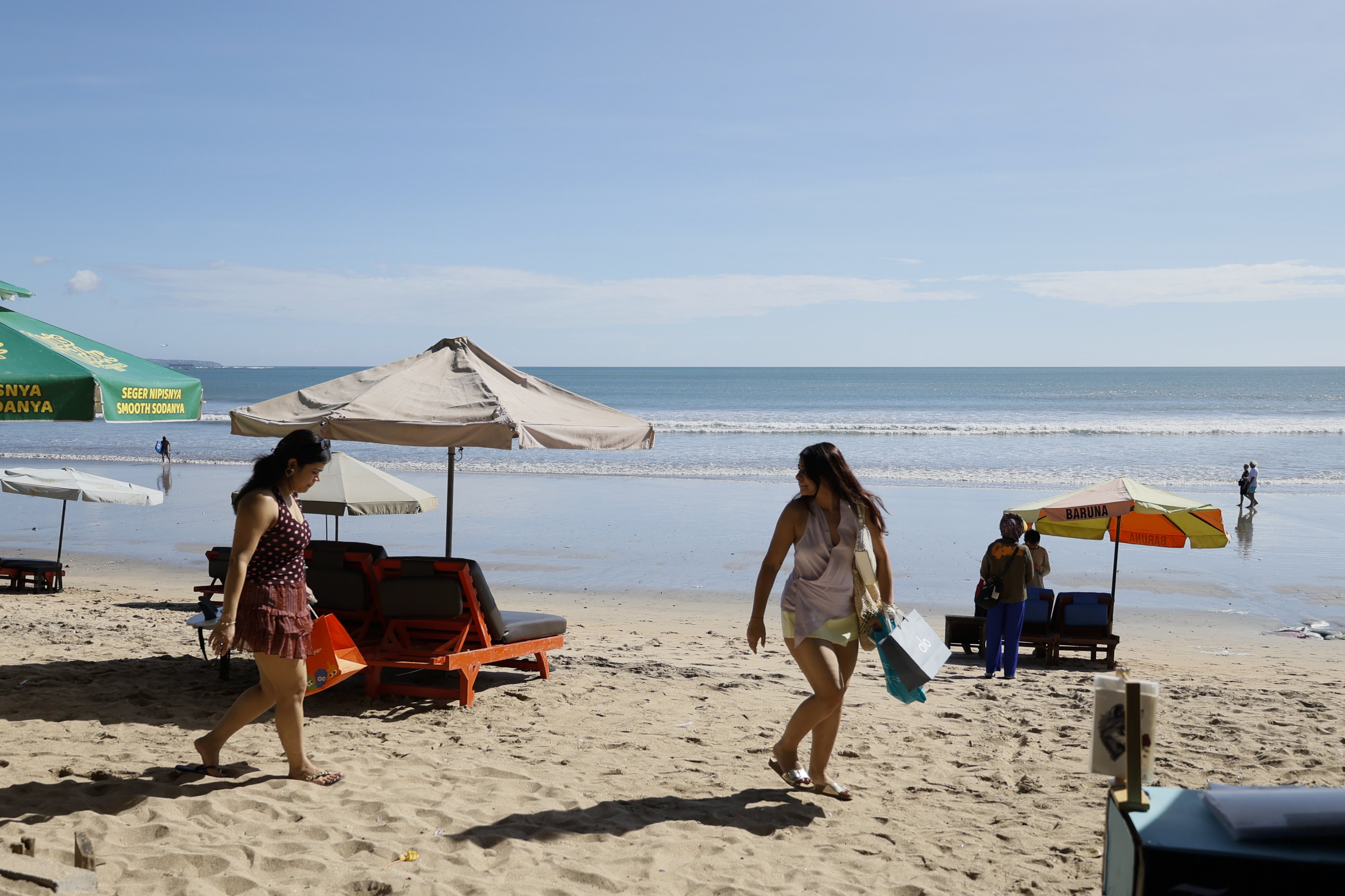 Tourists spend time at a beach in Kuta, Bali, Indonesia, on Monday. Photo: EPA