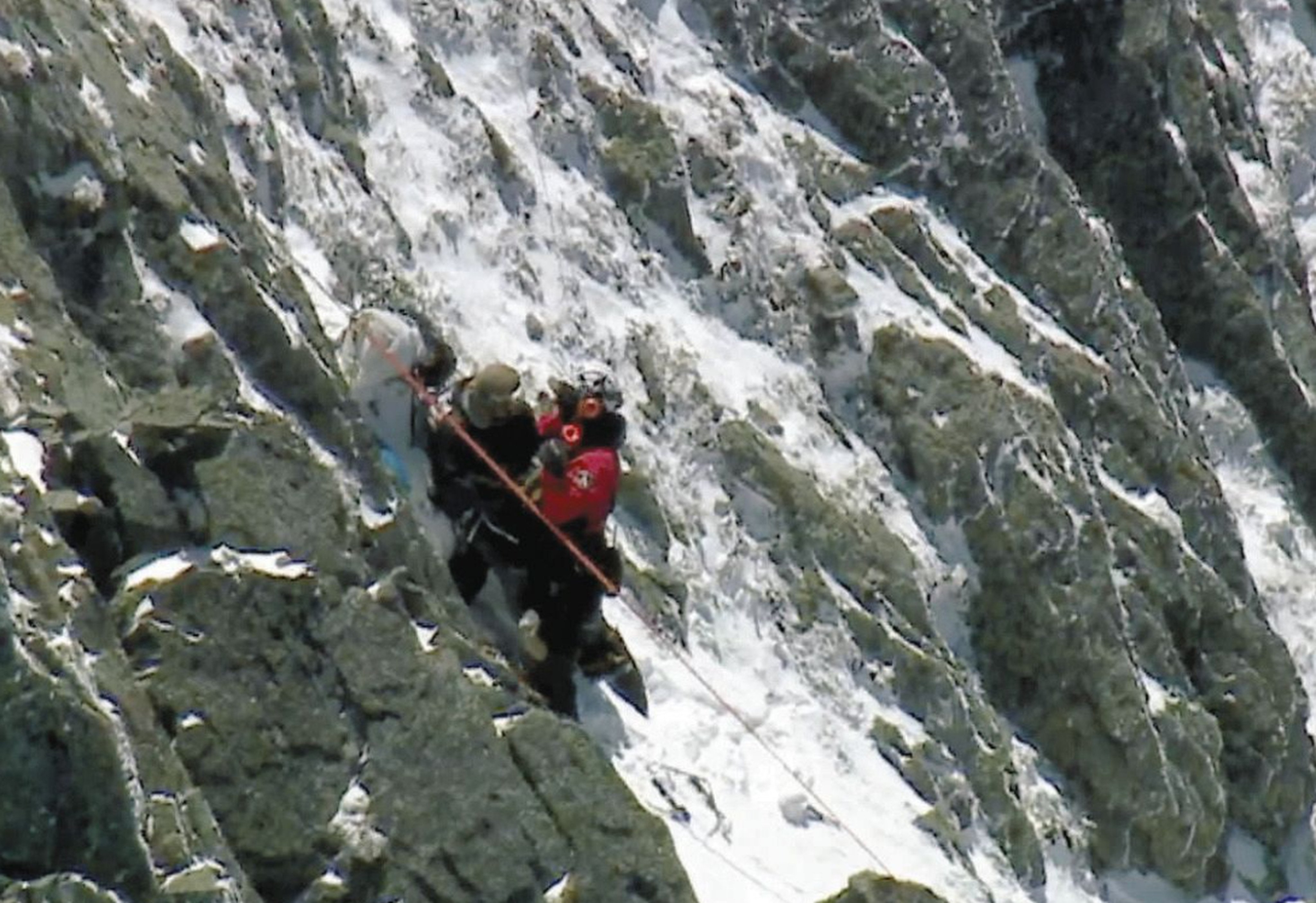 Firefighters from Nagano Prefecture’s disaster relief team rescue a stranded hiker (left). Photo: Handout
