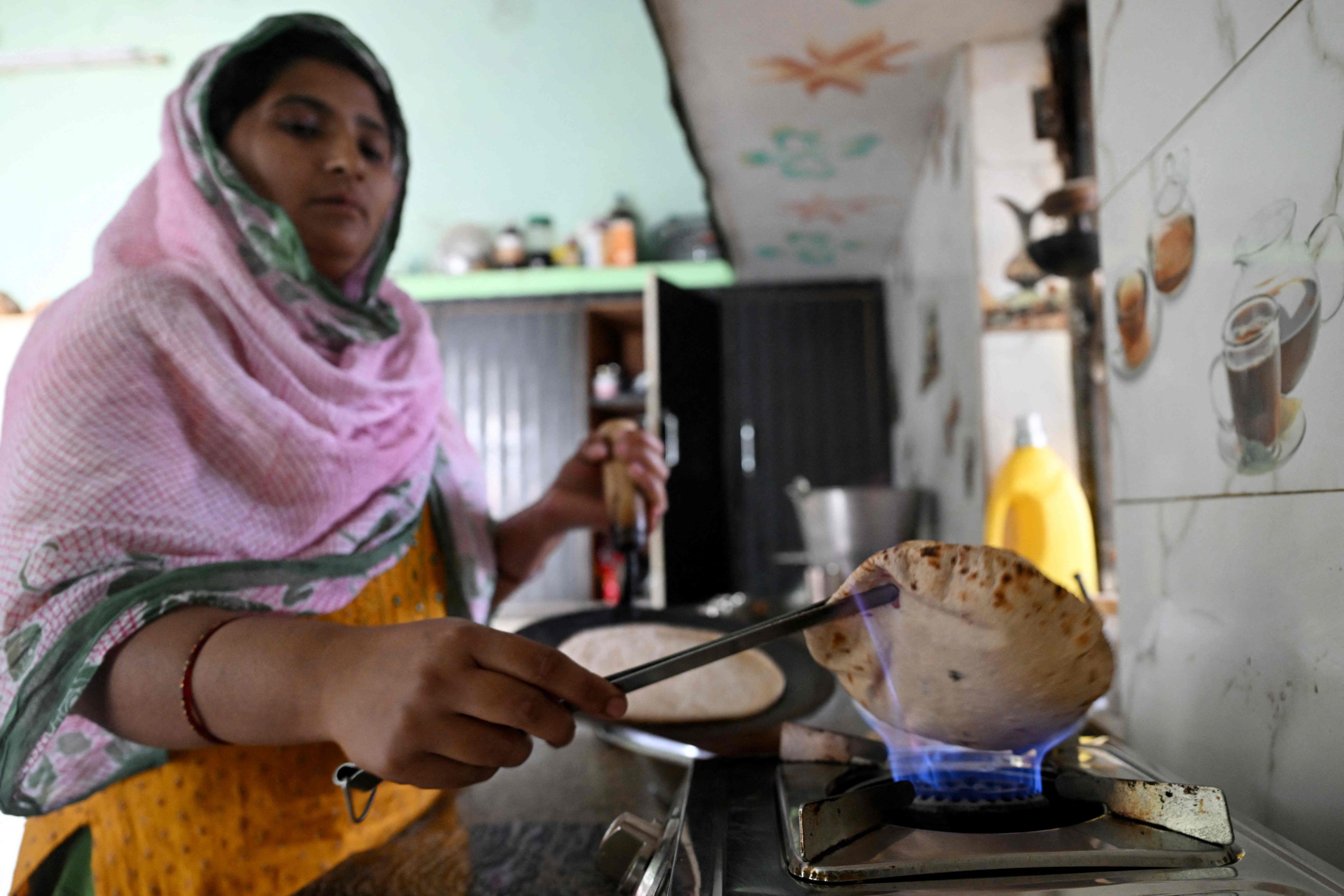 Gauri Devi cooks chapatti using biogas at her home in Uttar Pradesh’s Bulandshahr district on April 24. Photo: AFP