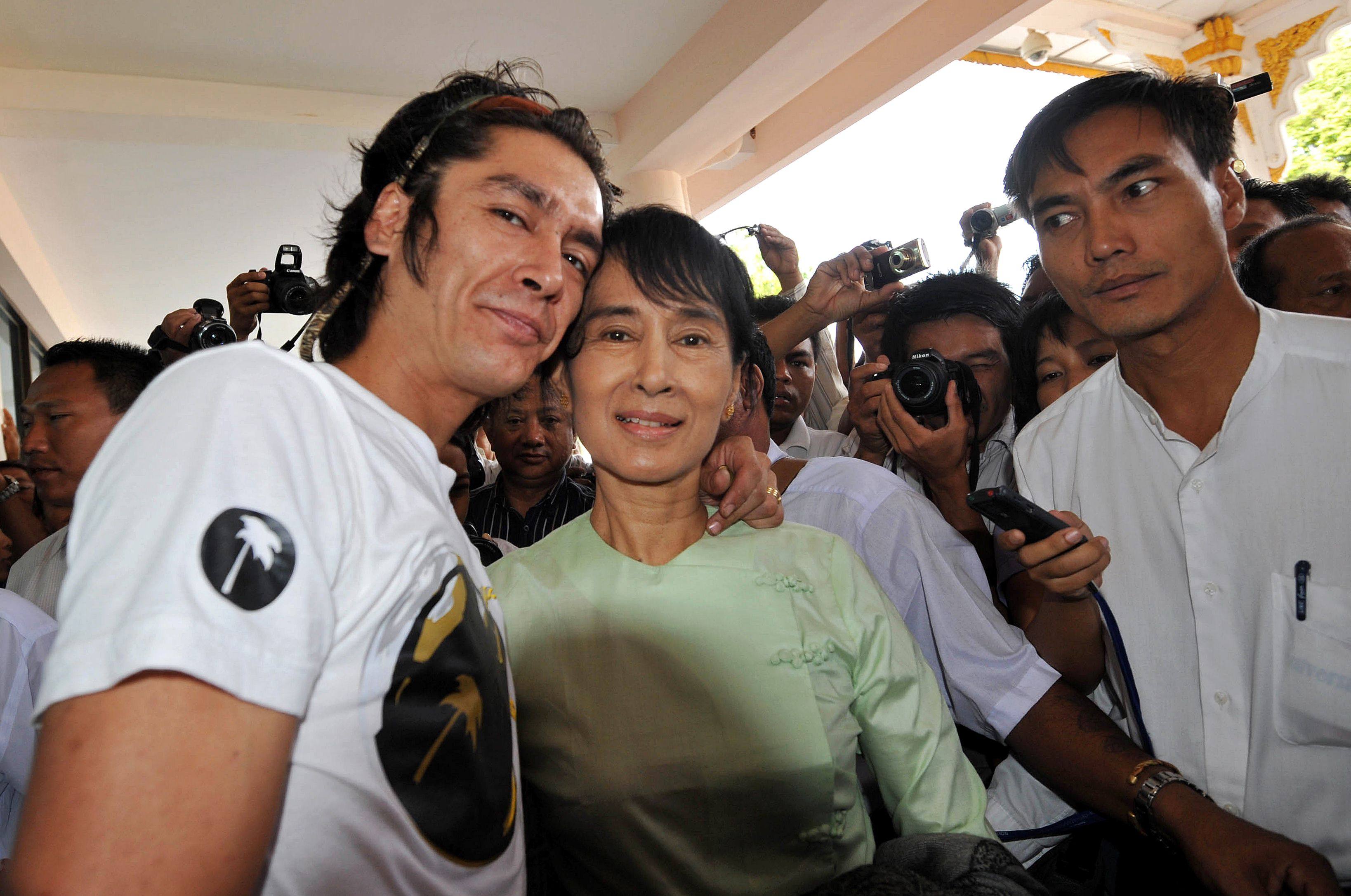 Aung San Suu Kyi and her son, Kim Aris, pose for pictures at the airport in the ancient temple city of Bagan before flying back to Yangon on July 8, 2011. Photo: AFP