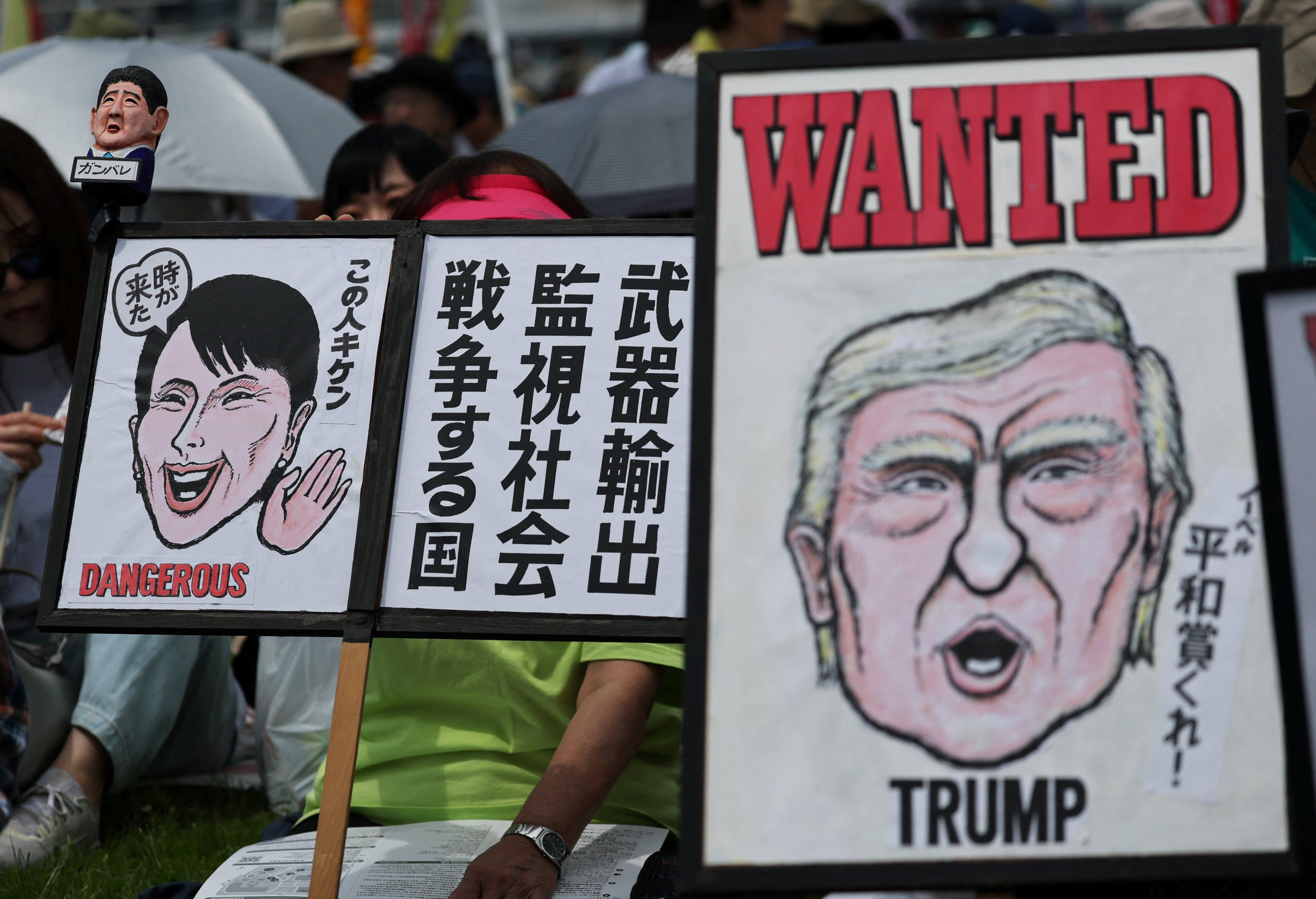 Protesters hold placards representing Japan’s Prime Minister Sanae Takaichi and US President Donald Trump at a demonstration in Tokyo on Sunday. Photo: Reuters