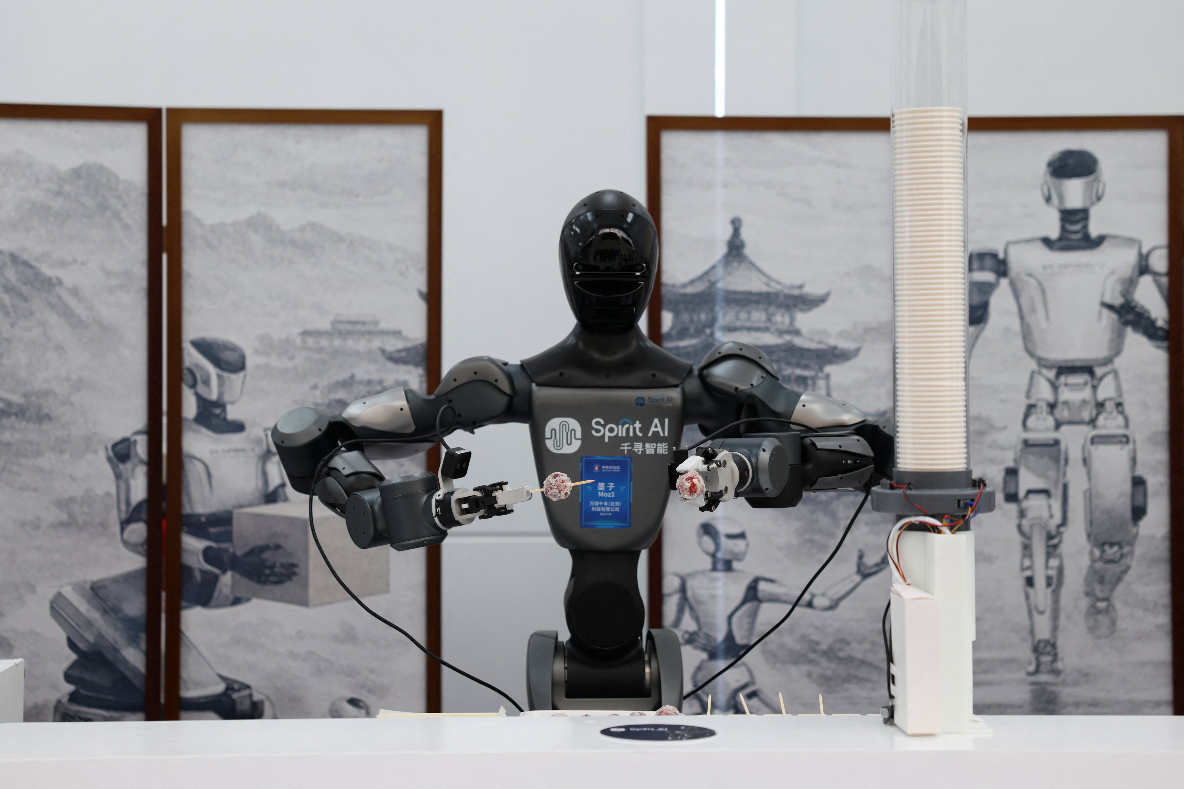 A Moz1 humanoid robot by Spirit AI serves candied fruit skewers at the 2026 Zhongguancun forum in Beijing on March 25. Photo: Reuters