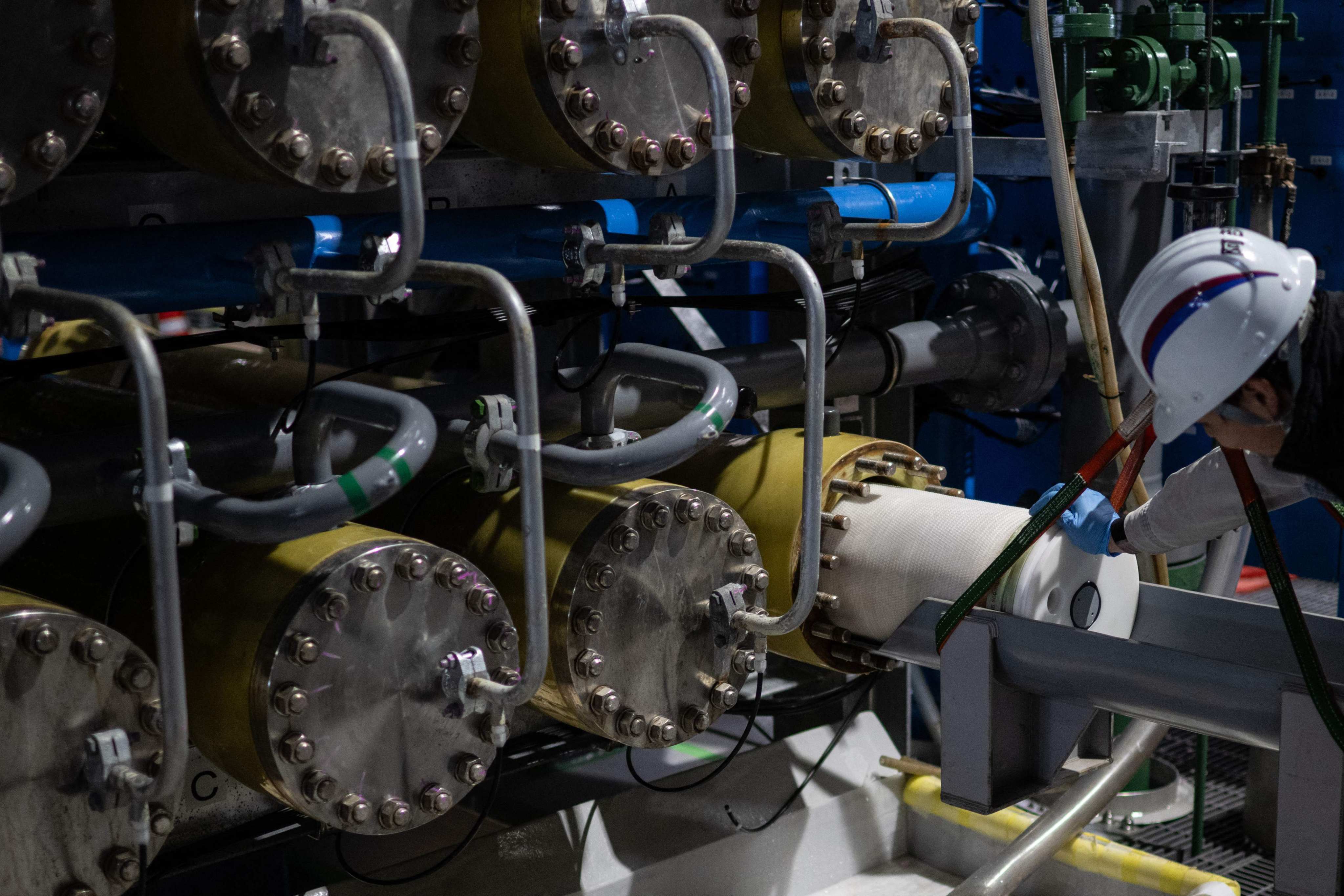 A staff member at the Sea Water Desalination Plant in Fukuoka changes part of the osmosis membrane facilities. Photo: AFP