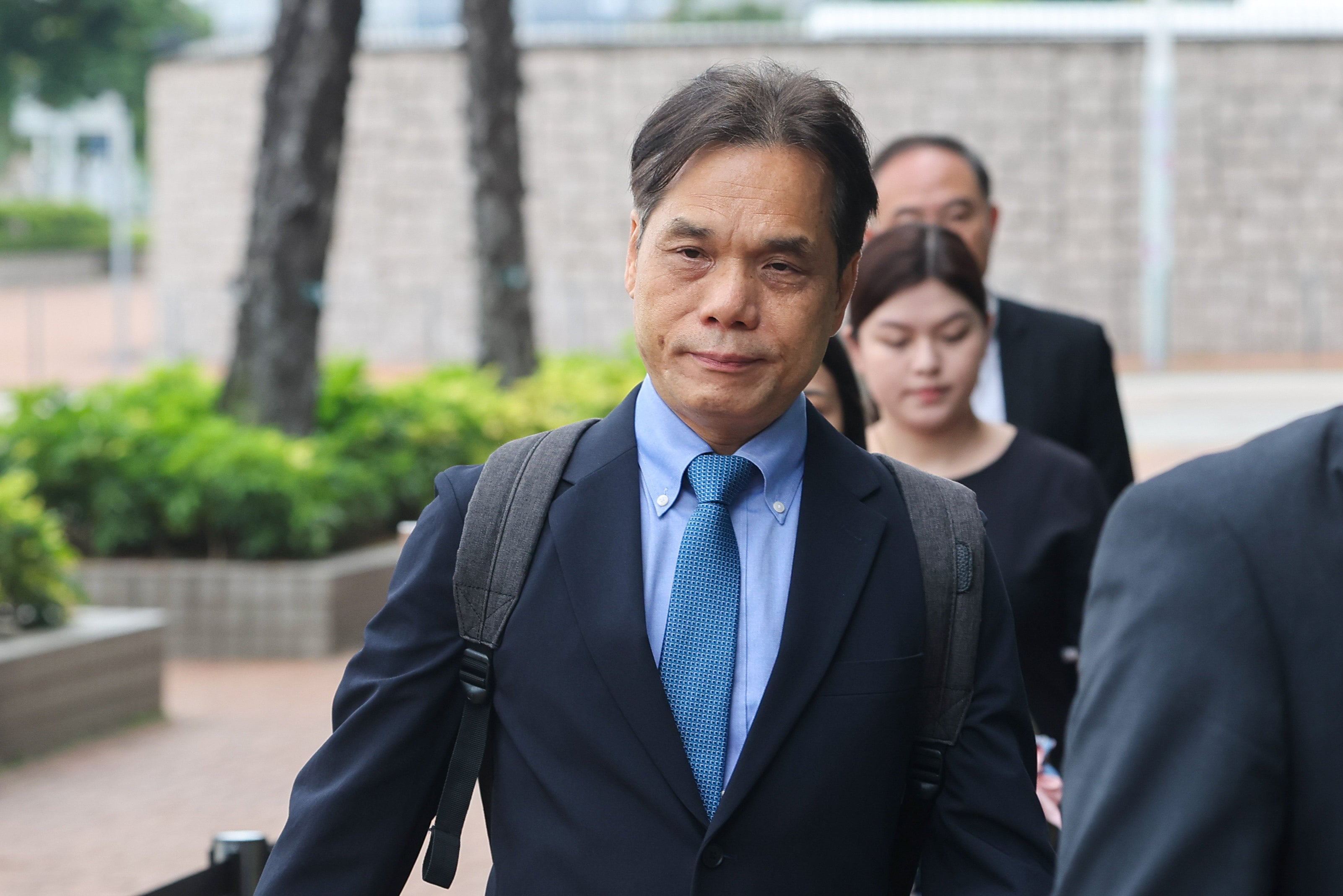Andy Ku (centre), a senior maintenance surveyor for the Housing Bureau’s Independent Checking Unit, at City Gallery in Central for the hearing. Photo: Edmond So