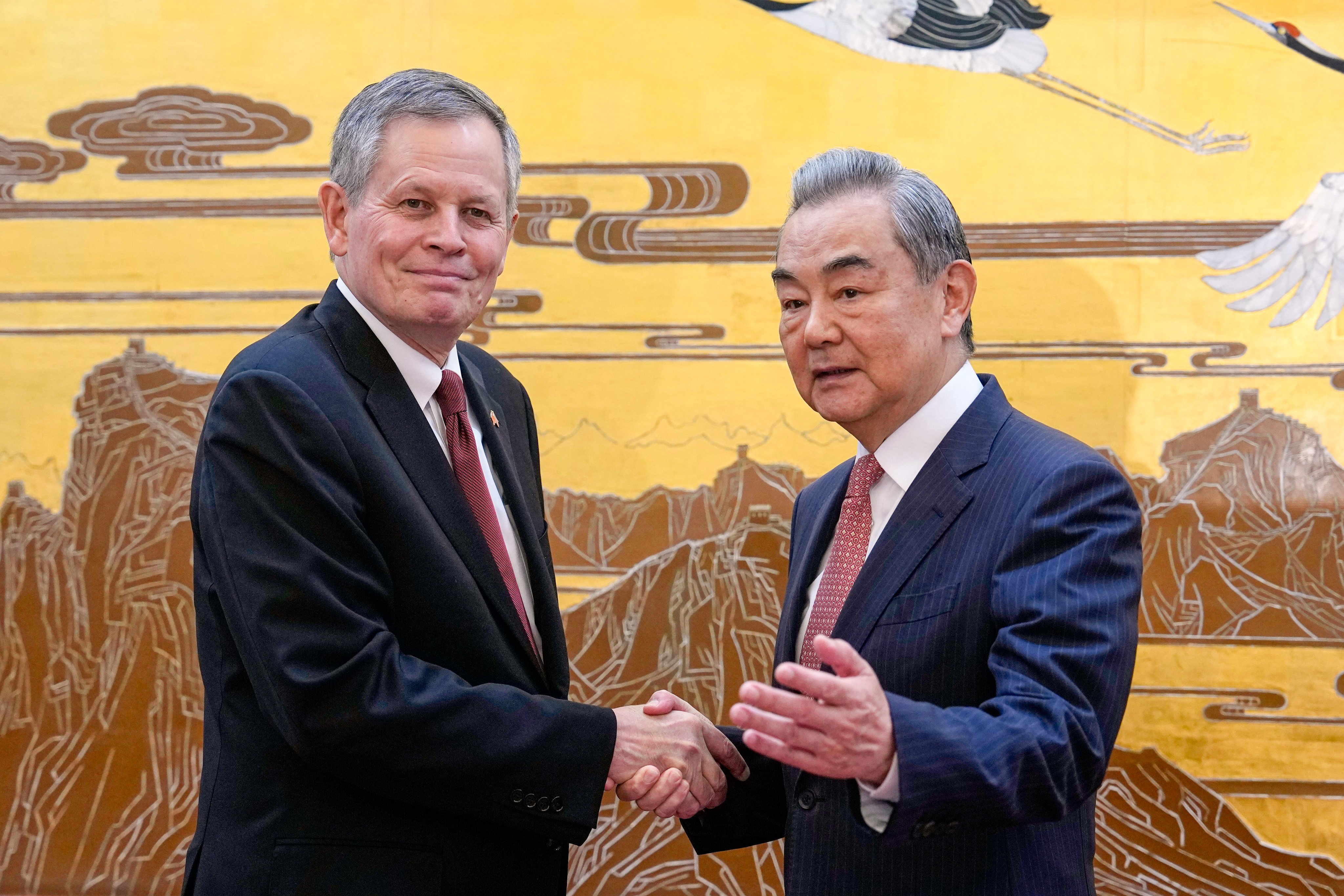 US Senator Steve Daines is greeted by Chinese Foreign Minister Wang Yi at the Great Hall of the People in Beijing on Thursday. Photo: AP