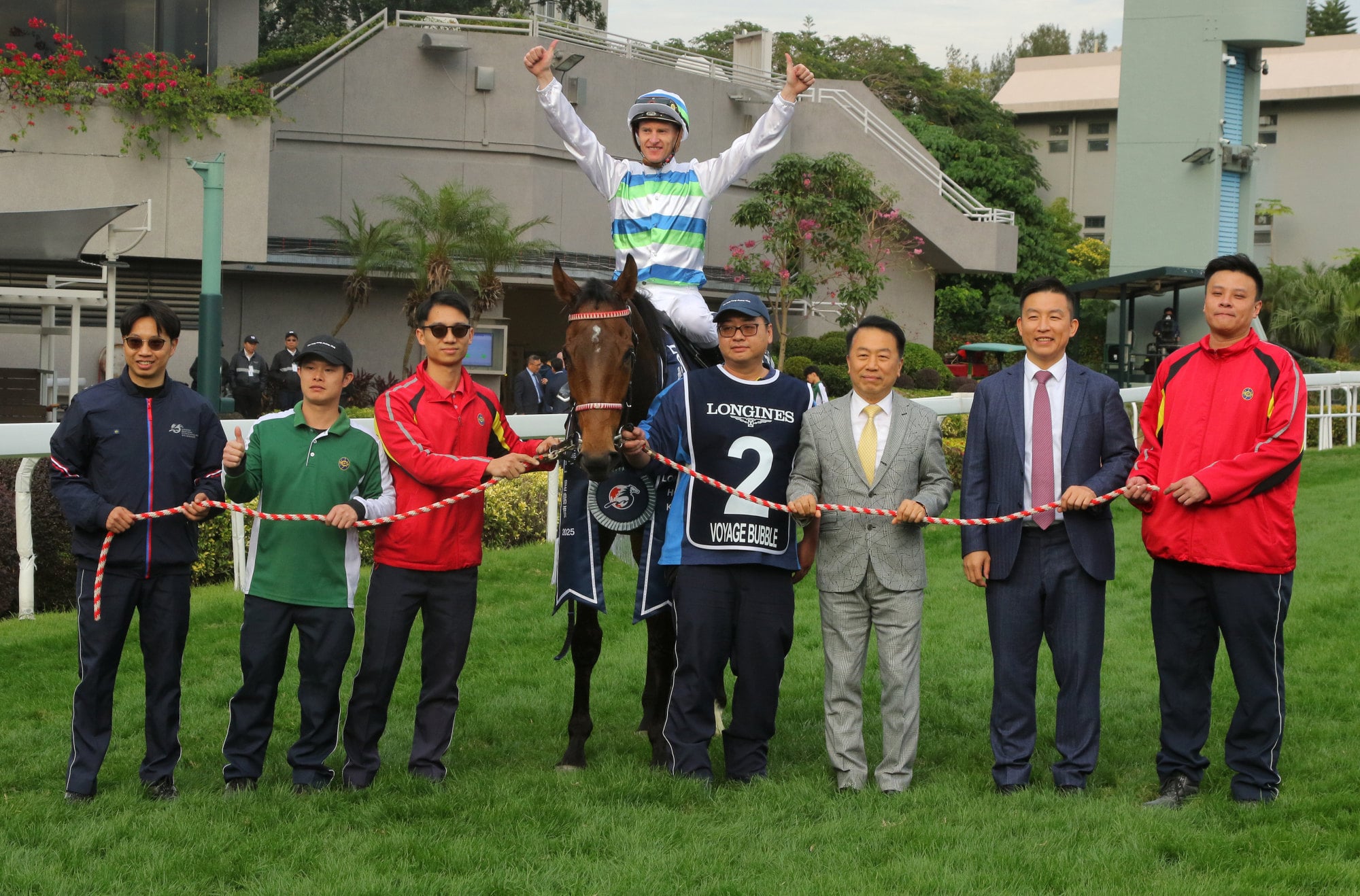 Ricky Yiu (third from right), jockey Zac Purton and stable staff celebrate Voyage Bubble’s Hong Kong Mile triumph in December.