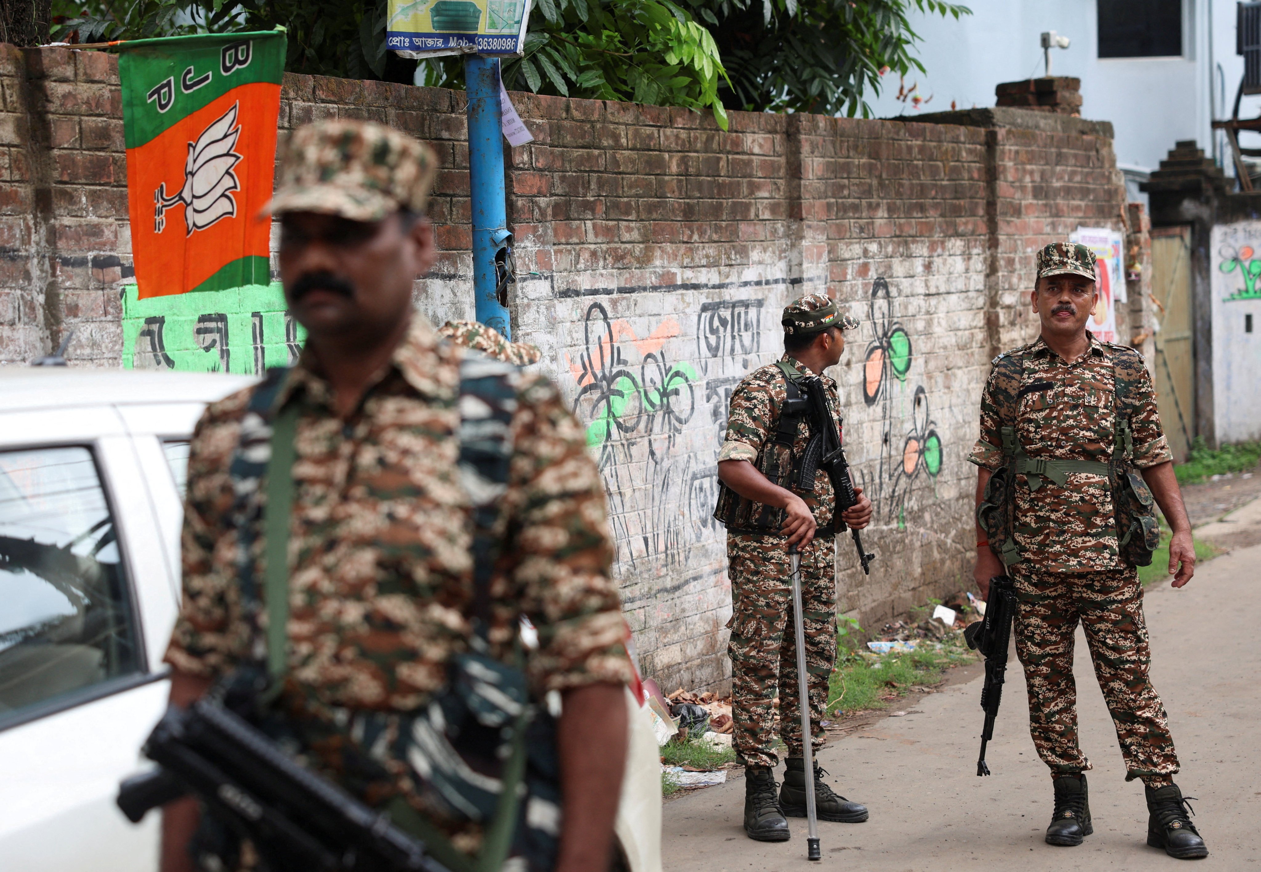 Members of security forces stand guard on Thursday along a road leading to the spot where Chandranath Rath was shot dead. Photo: Reuters