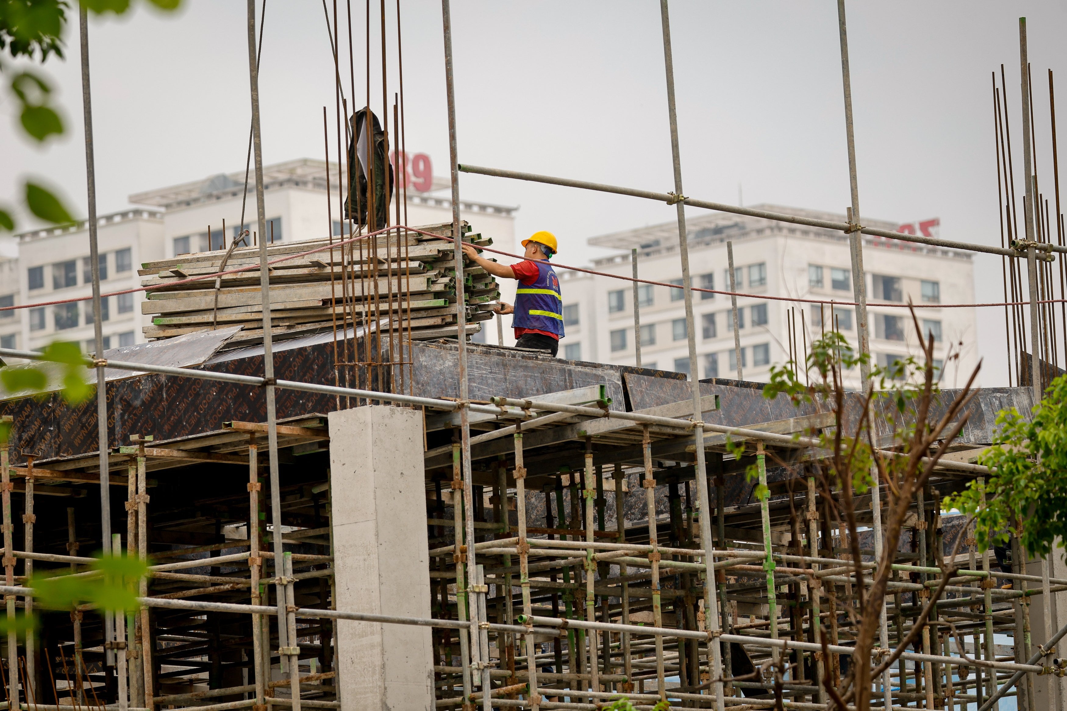 A labourer works at a construction site in Hanoi in April. Vietnam’s President To Lam has set an annual growth target of 10 per cent until 2030. Photo: EPA