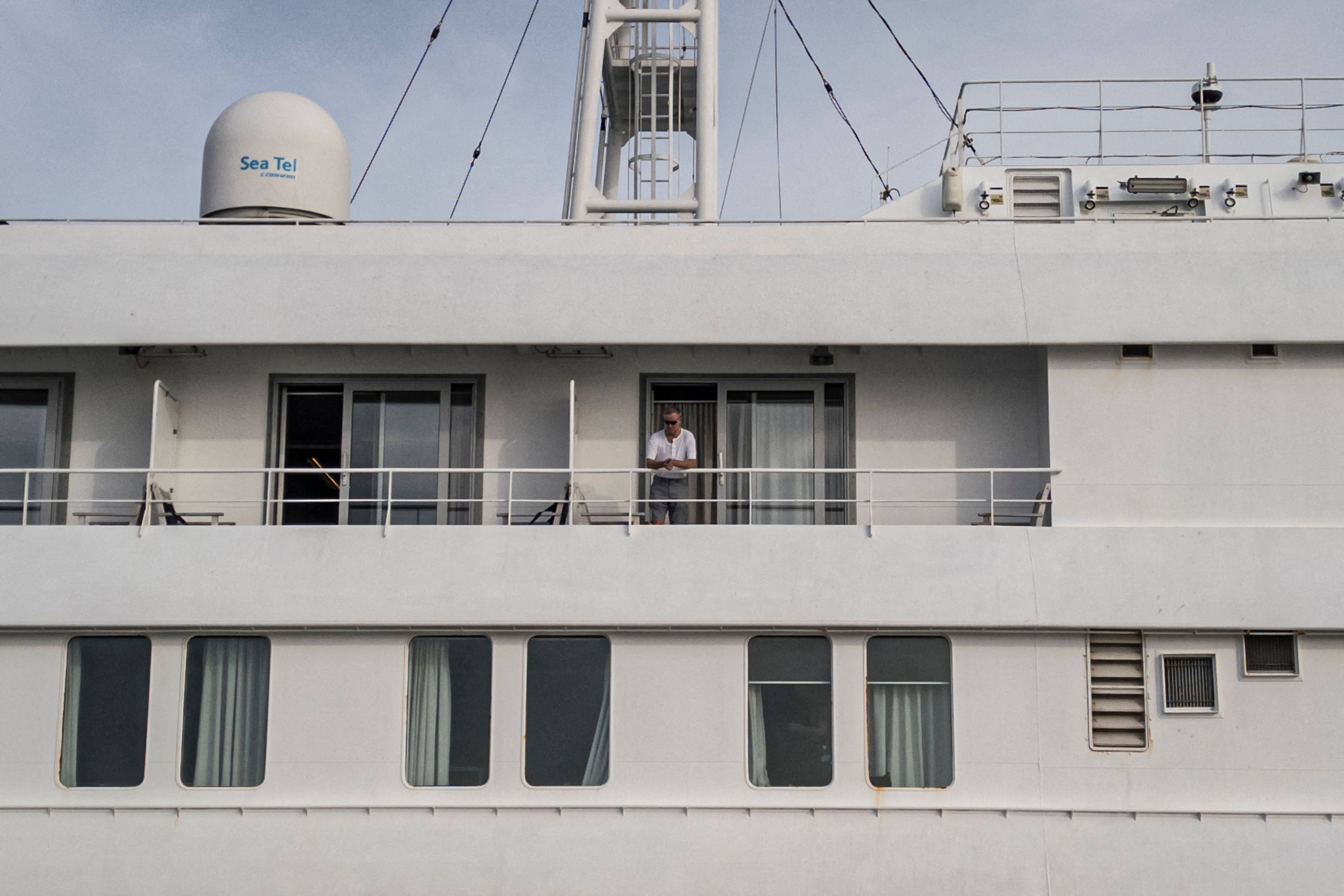 A passenger on the MV Hondius watches as health personnel (not pictured) assist patients off the cruise ship and onto a boat off the port of Praia, Cabo Verde, on Wednesday. Photo: AFP