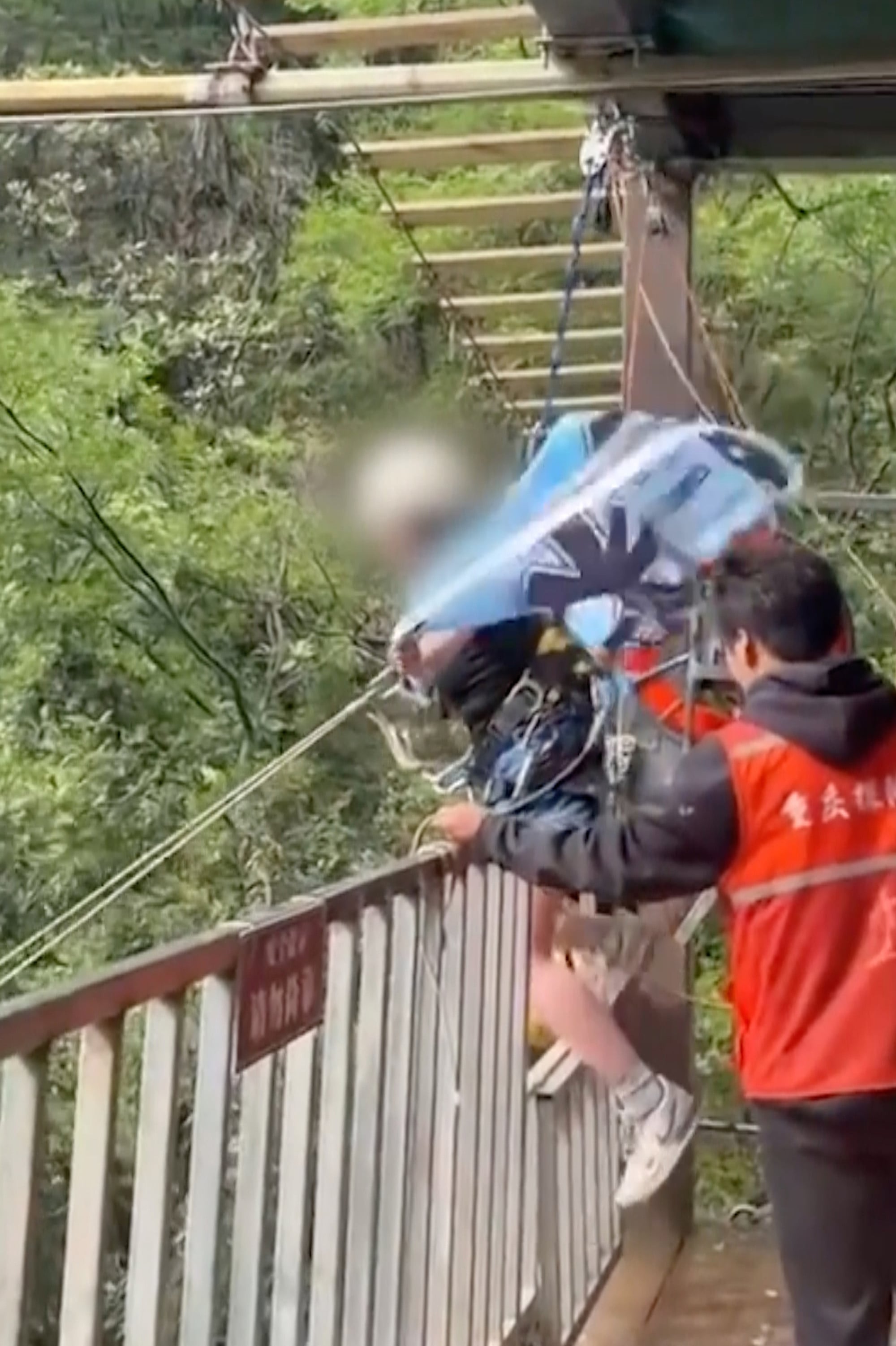 Liu, above, being helped onto the swing by safety staff just seconds before tragedy struck. Photo: Handout