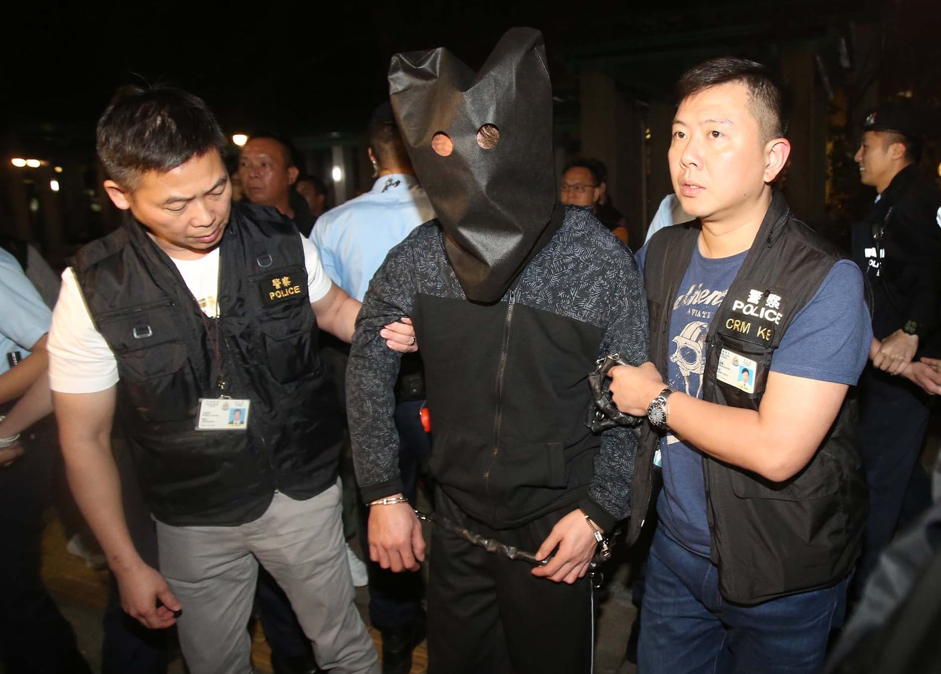 Police escort the murder suspect to Po Lam Estate for investigation in March 2019. Photo: Handout