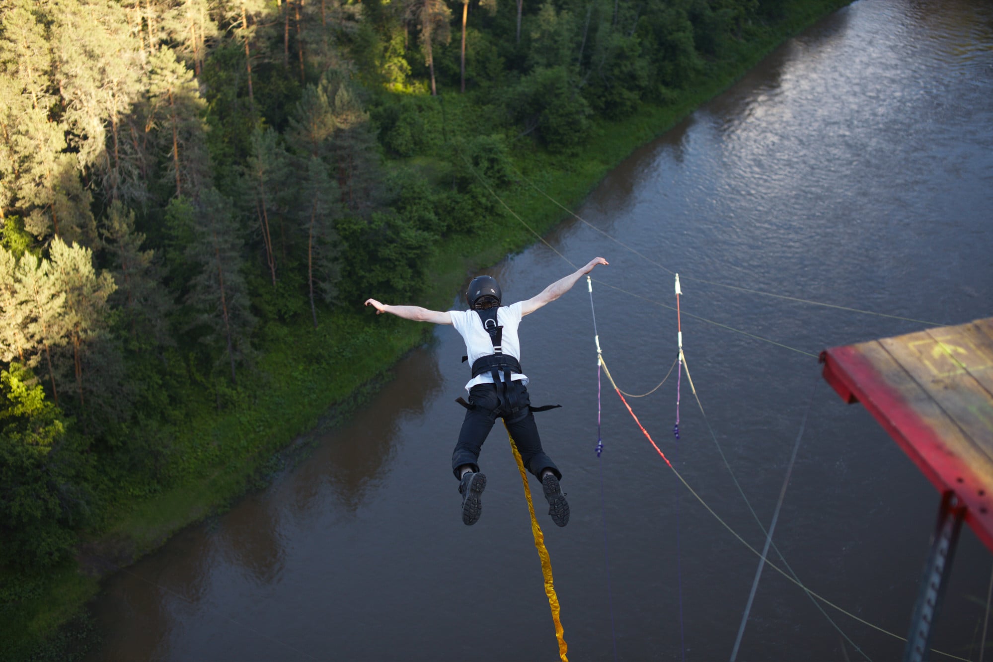 An extreme sportsman falls into a deep canyon tied to a safety rope. Photo: Shutterstock