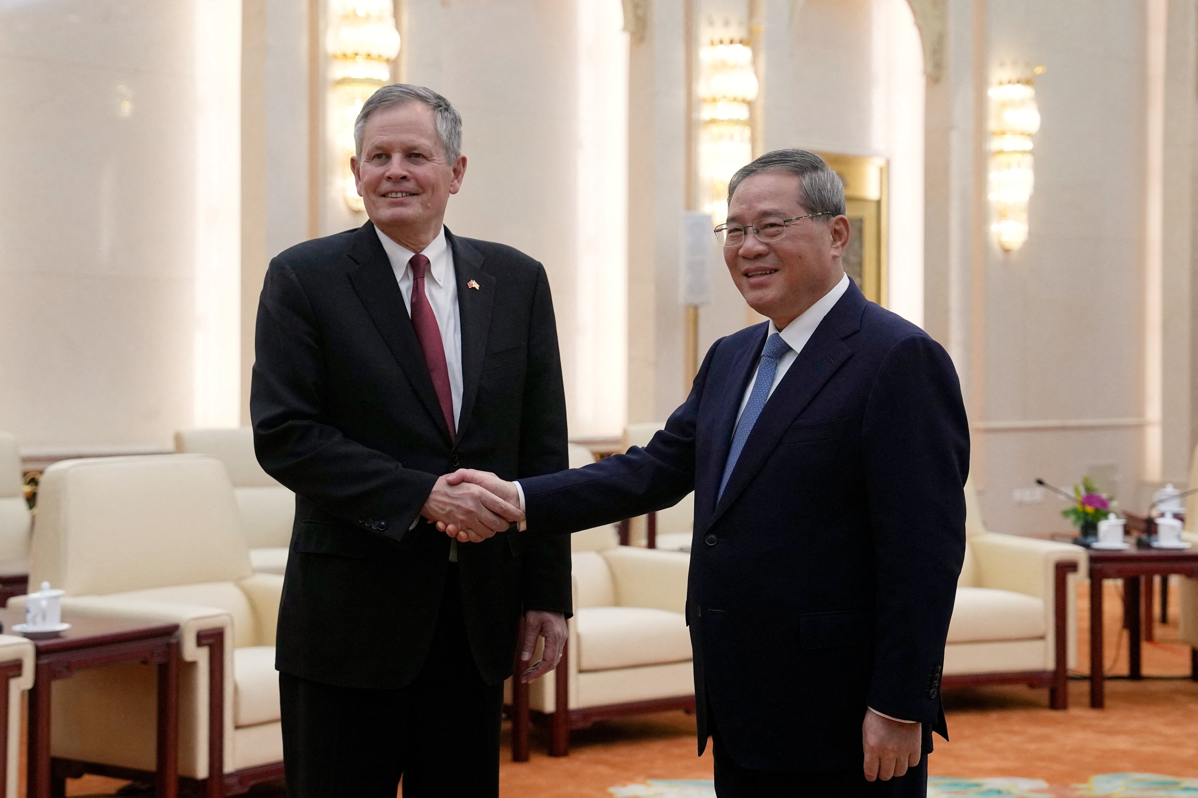 Chinese Premier Li Qiang and US Senator Steve Daines pose for photos ahead of their meeting at the Great Hall of the People, in Beijing on Thursday. Photo: Pool via Reuters