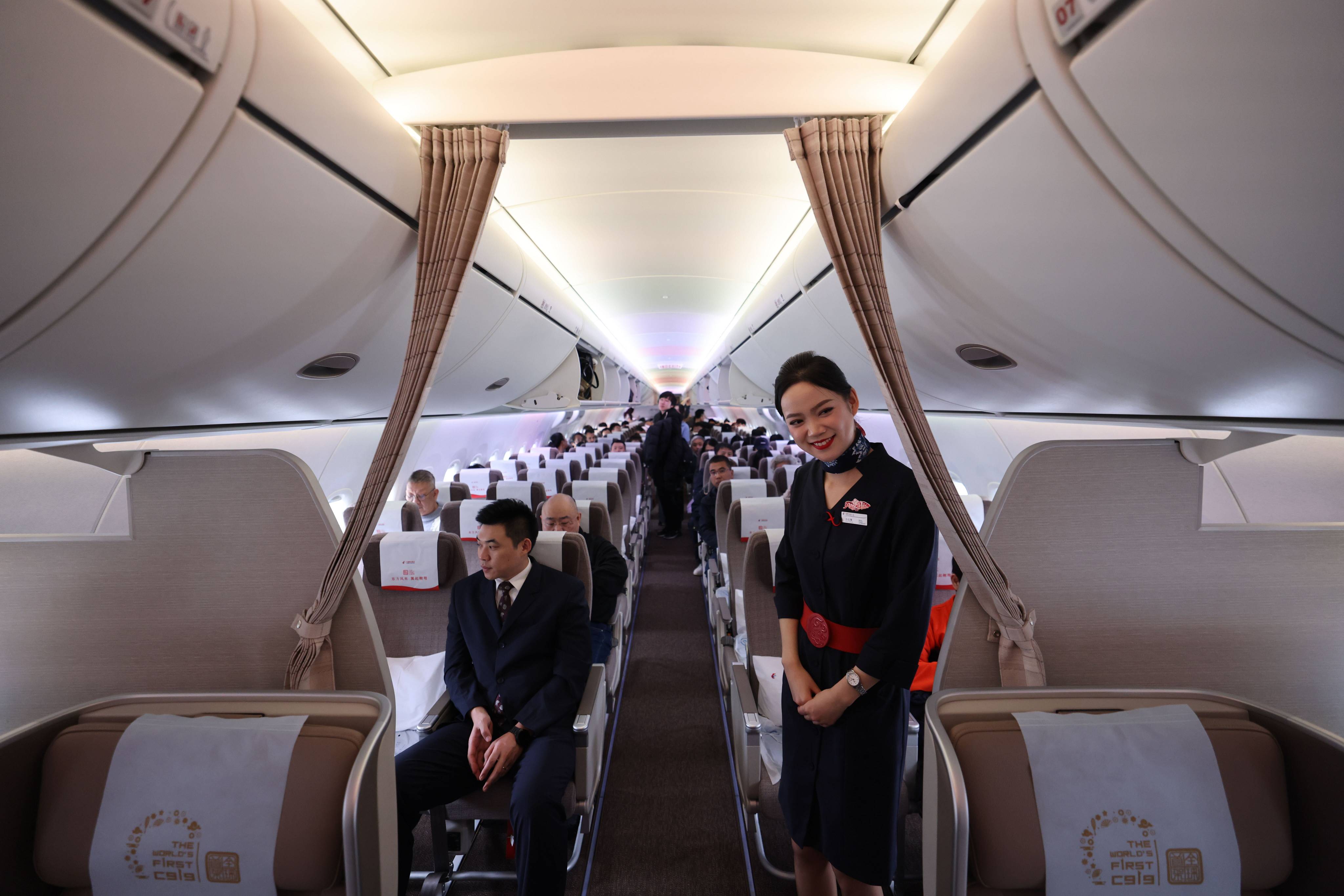 A flight attendant welcomes passengers on board a China Eastern Airlines C919 at Hong Kong International Airport last year. Photo: Nora Tam