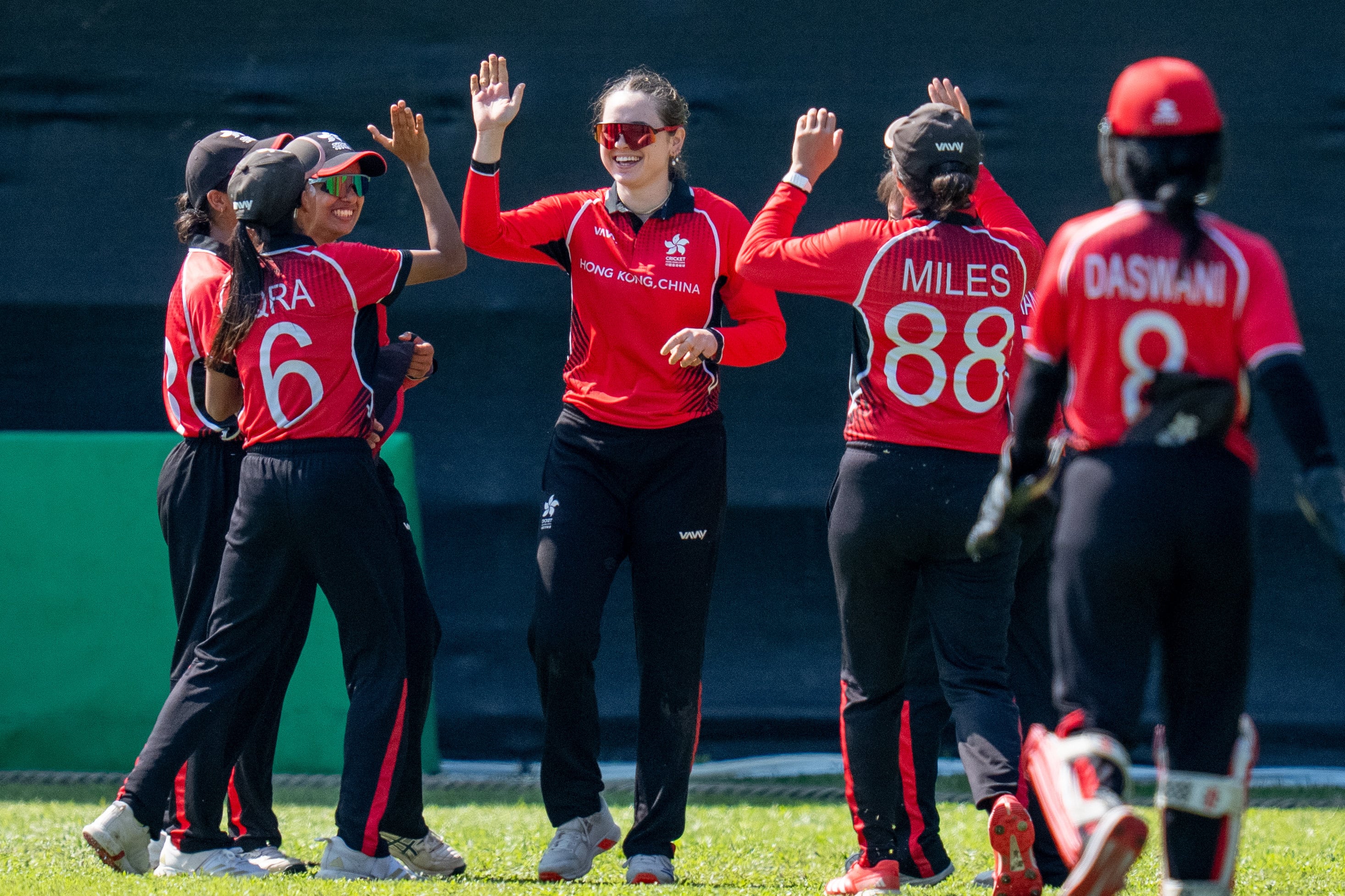 Marina Lamplough’s Hong Kong teammates rush to congratulate her on a fine boundary catch. Photo: Cricket Association of Hong Kong, China