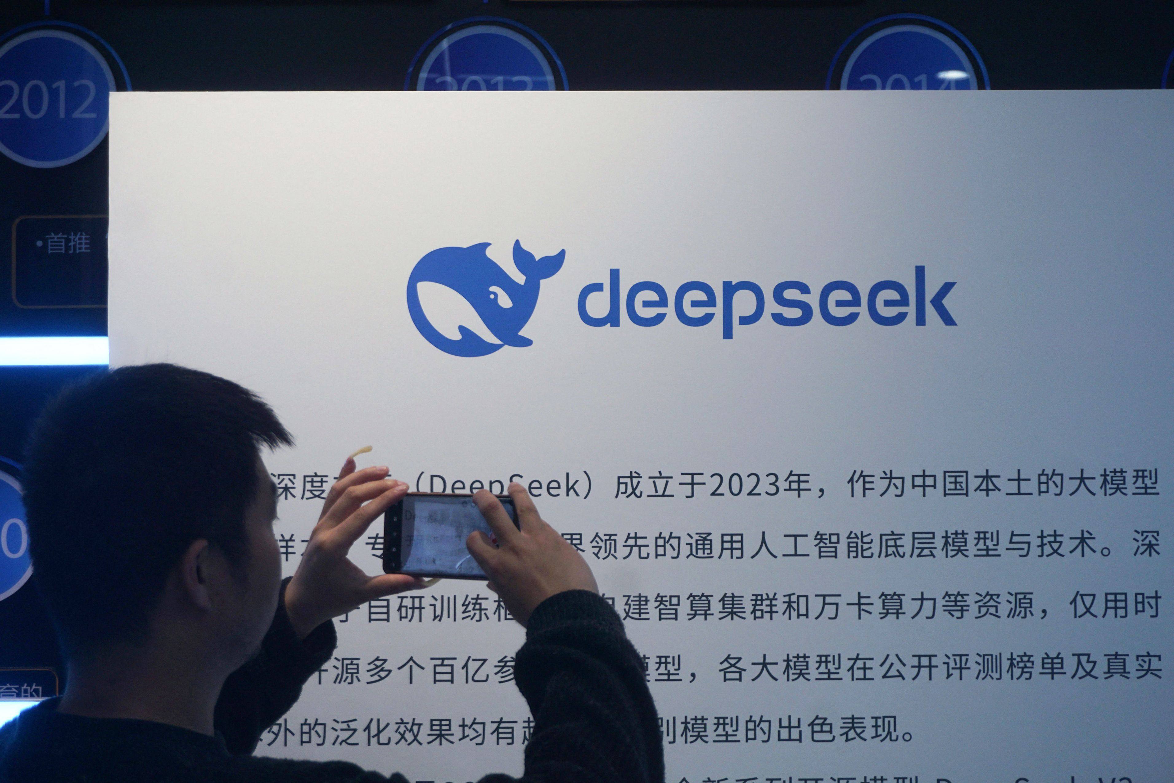 A man takes a photo of a DeepSeek display at a shopping mall in Hangzhou, in China’s eastern Zhejiang province, on April 23. Photo: AFP