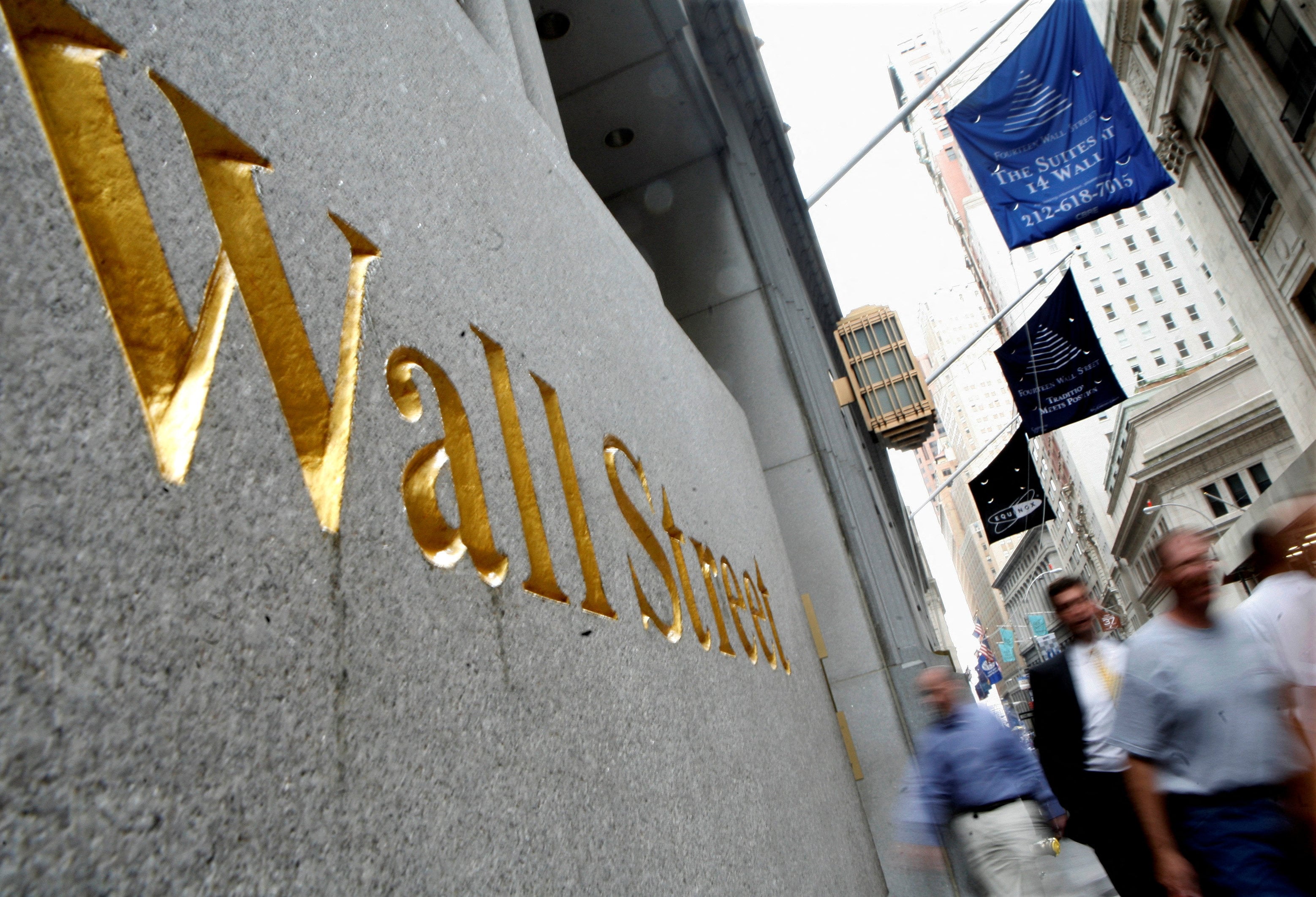 People walk along Wall Street near the New York Stock Exchange. Photo: Reuters