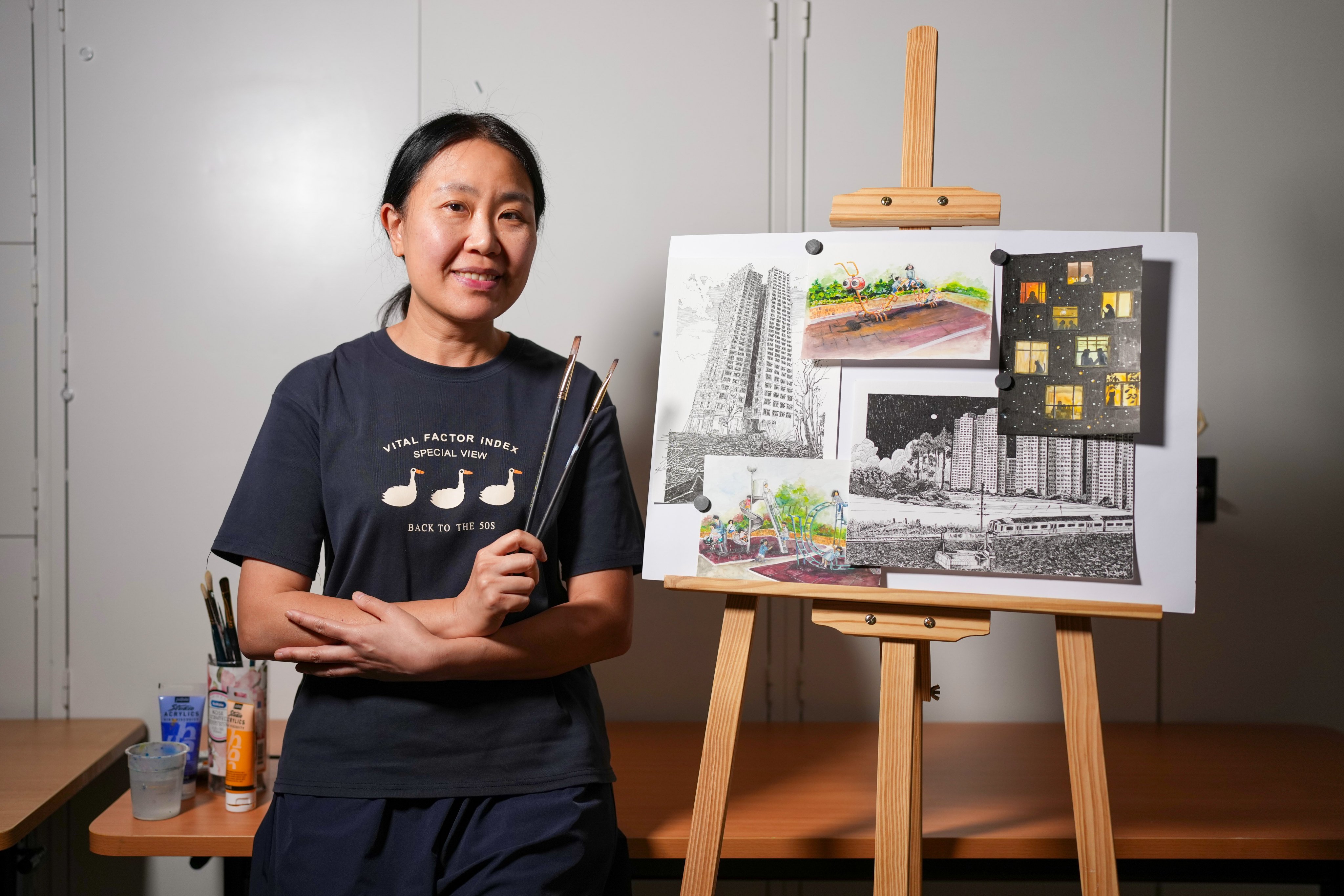 Apple Tong, a celebrated deaf Hong Kong illustrator, poses for a portrait at the ADA Arts Hub in Cheung Sha Wan. She is using art to heal from the Wang Fuk Court fire in Tai Po and to preserve the city’s vanishing heritage. Photo: Karma Lo