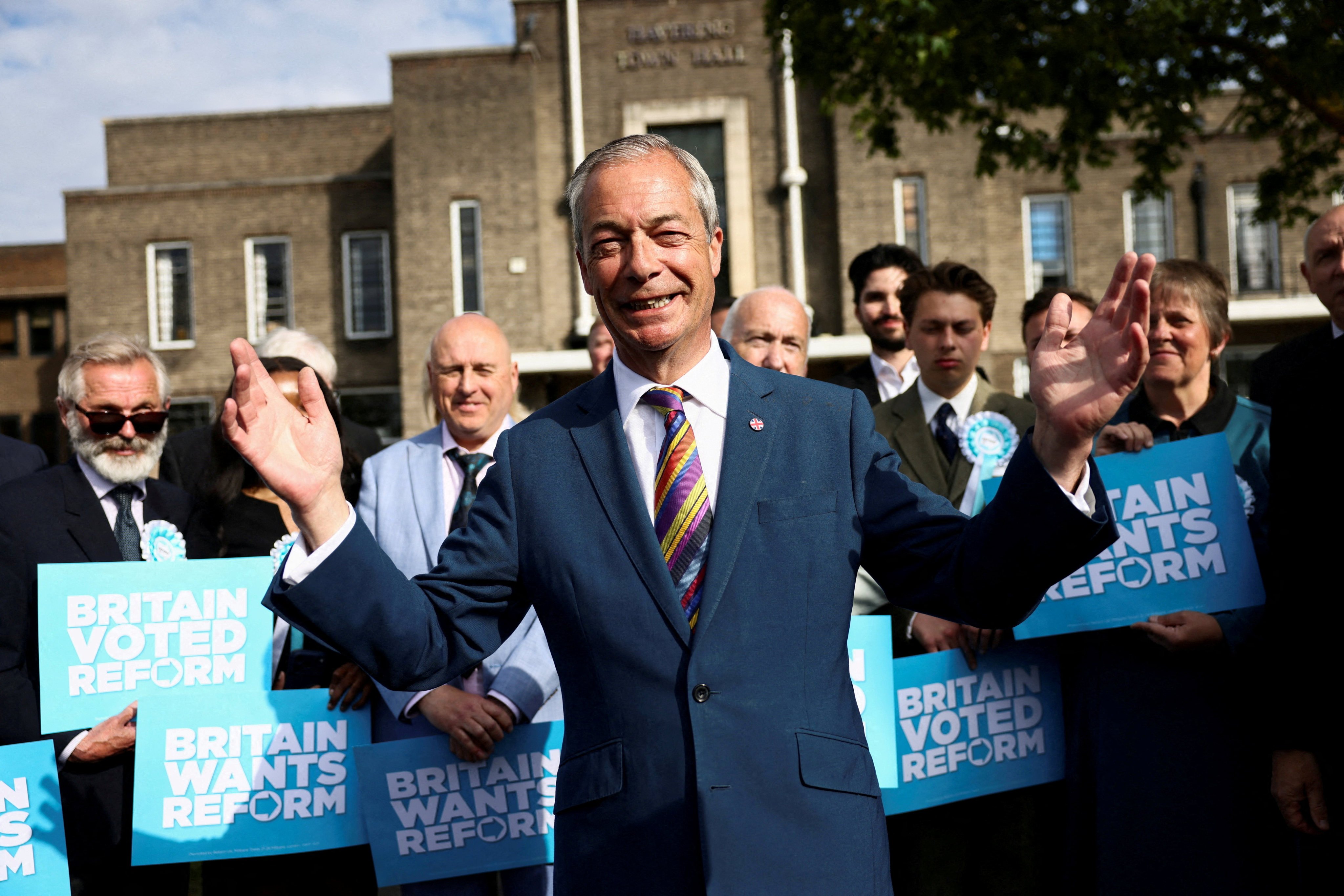 Britain’s Reform UK leader Nigel Farage reacts next to newly elected councillors at the Havering Town Hall, following the results of the local elections, in the London Borough of Havering, Britain on Friday. Photo: Reuters